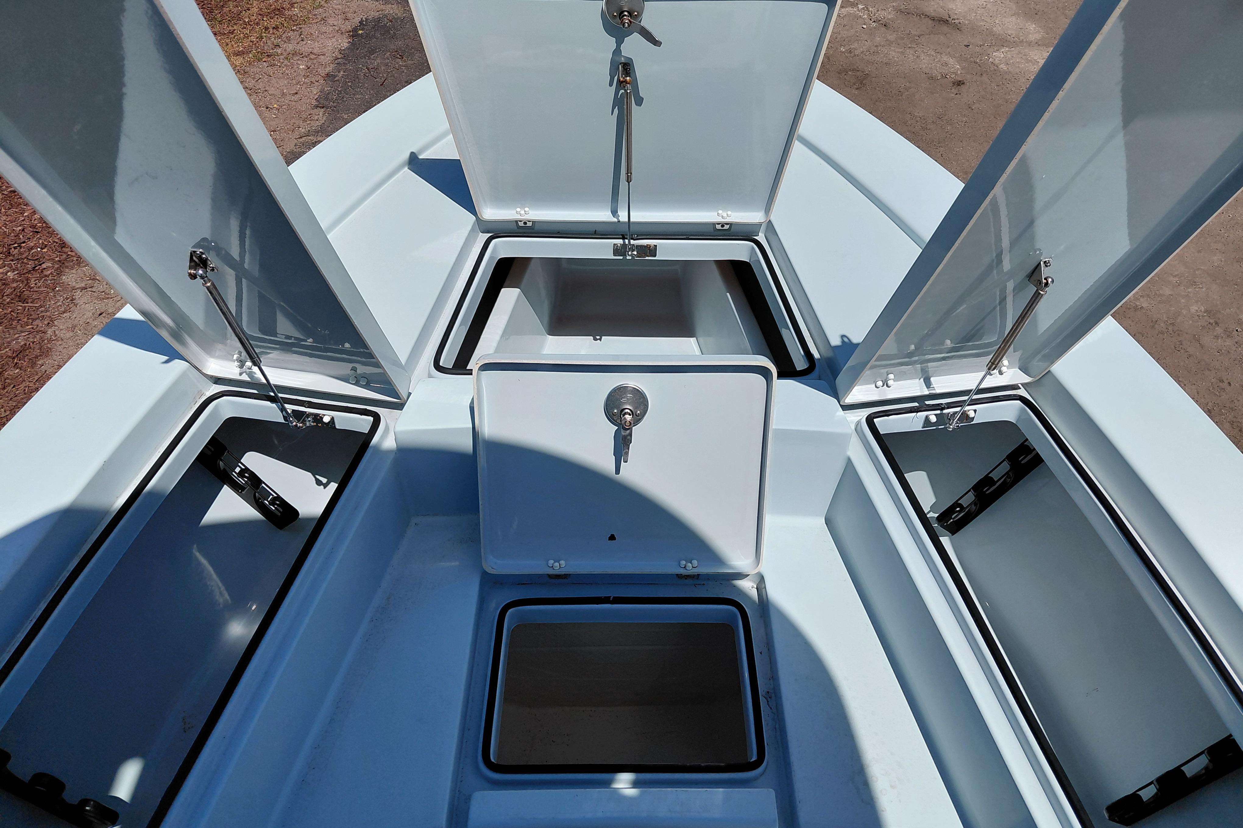 2022 Pathfinder 2300 HPS boat storage compartments open, showcasing spacious interior design.
