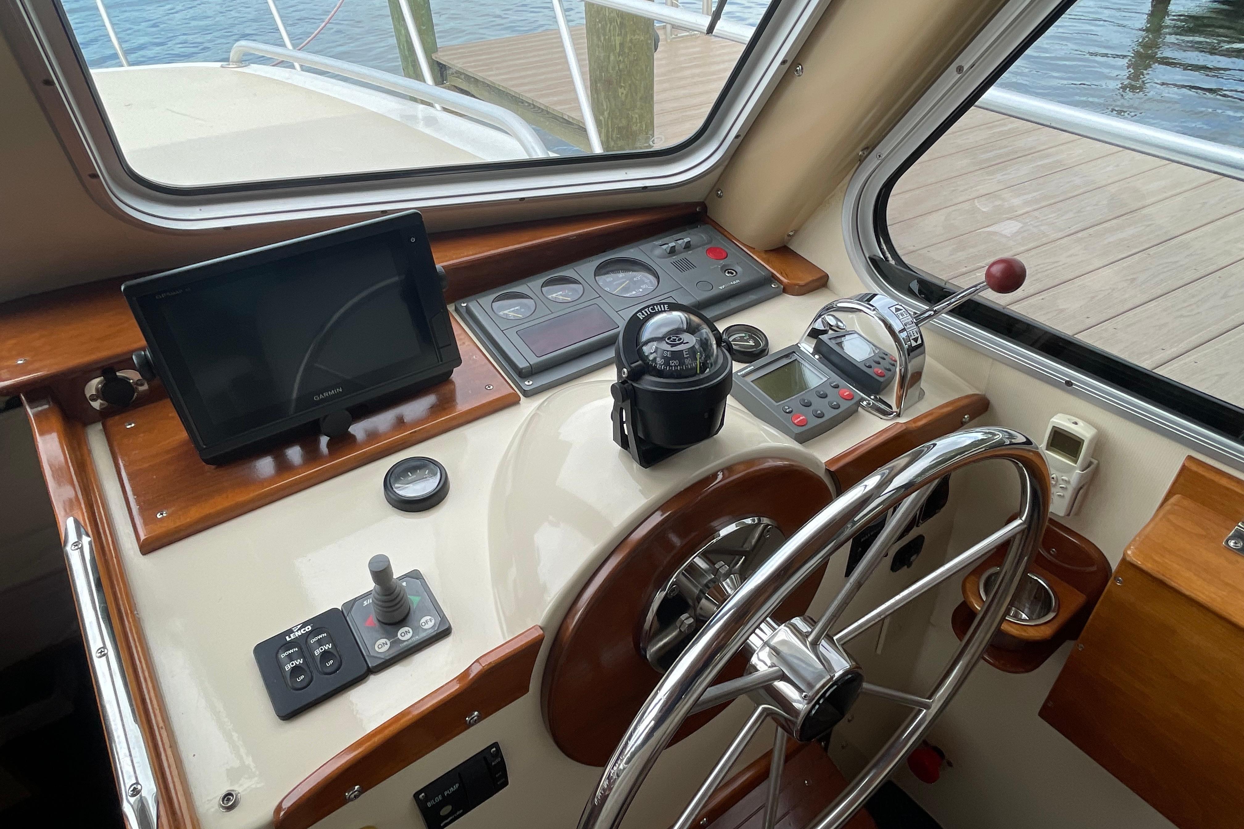 Helm of 2005 Fox Island Thirty Sedan Cruiser with navigation equipment and steering wheel.