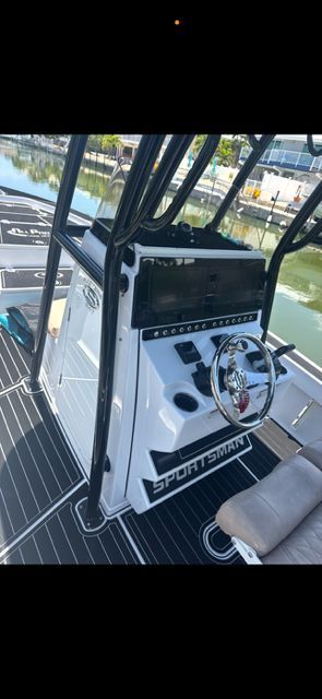 2020 Sportsman Masters 247 Bay Boat console by the water.