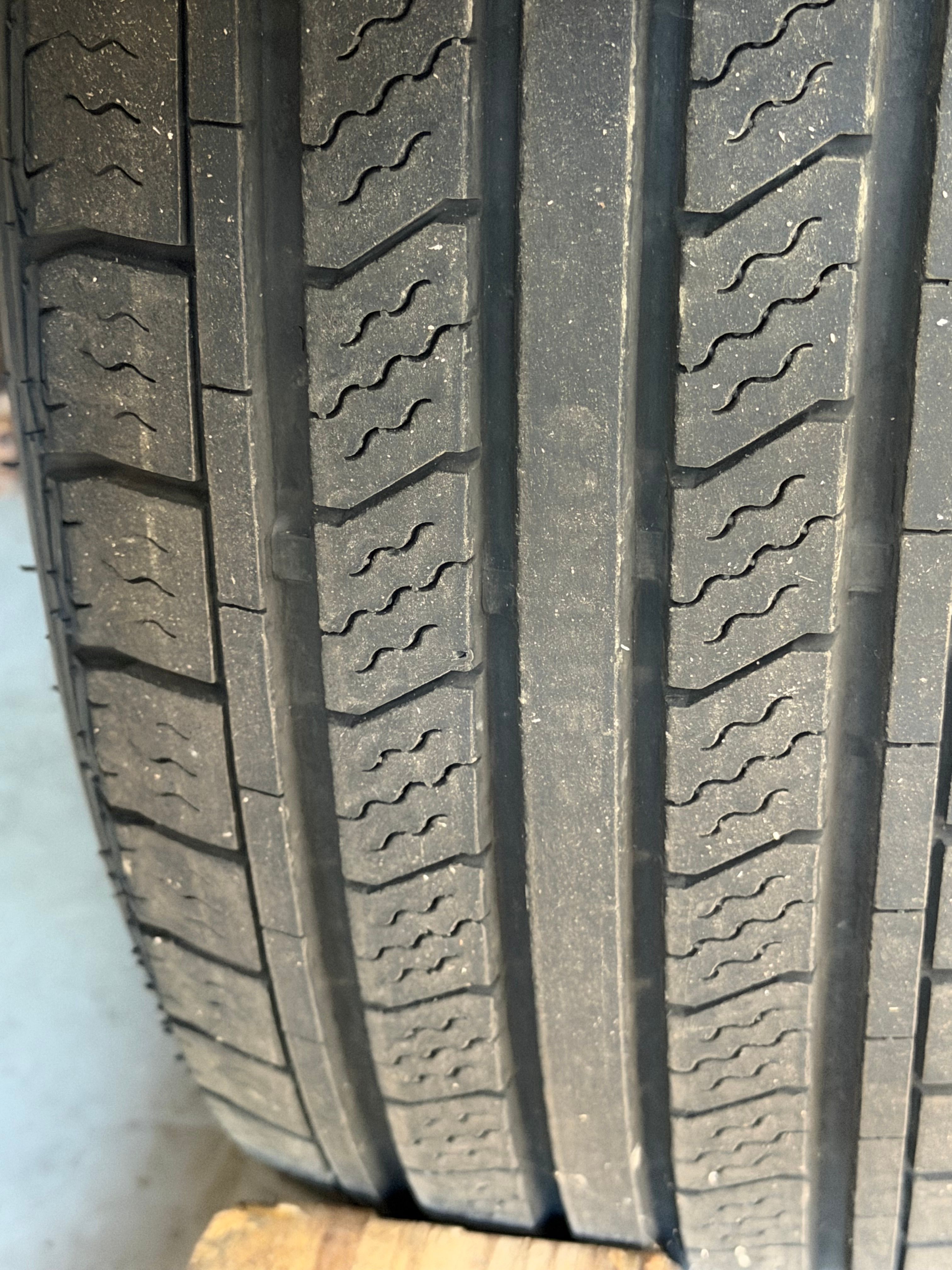 Close-up of a tire with distinct tread grooves.