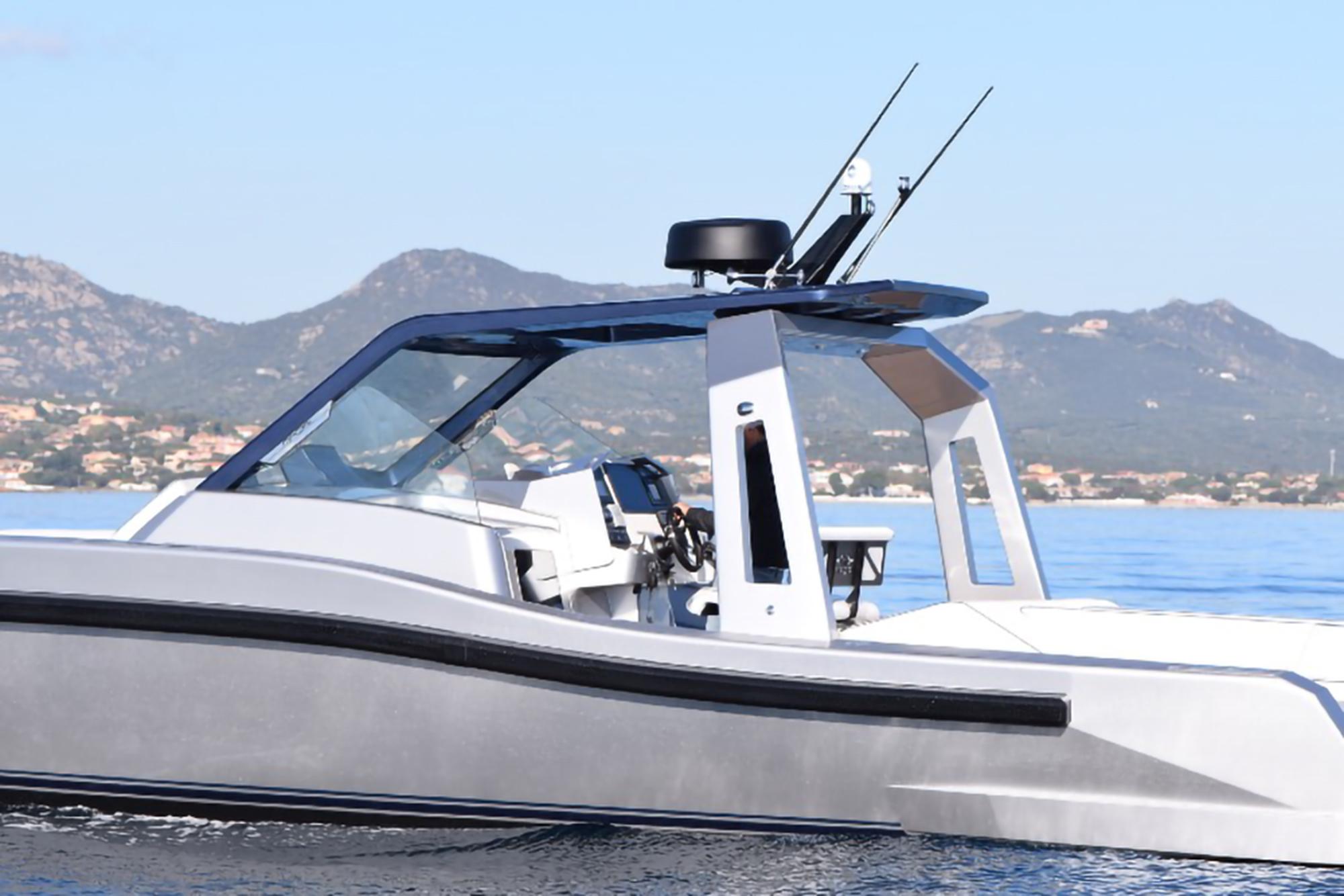 Modern 2017 Maori 50 boat cruising on calm waters with mountainous background.