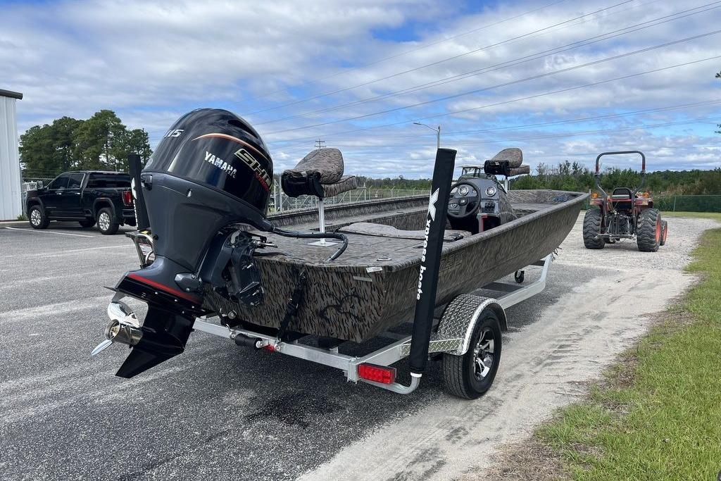 2026 Xpress XP200 boat with Yamaha engine on trailer, parked outdoors.