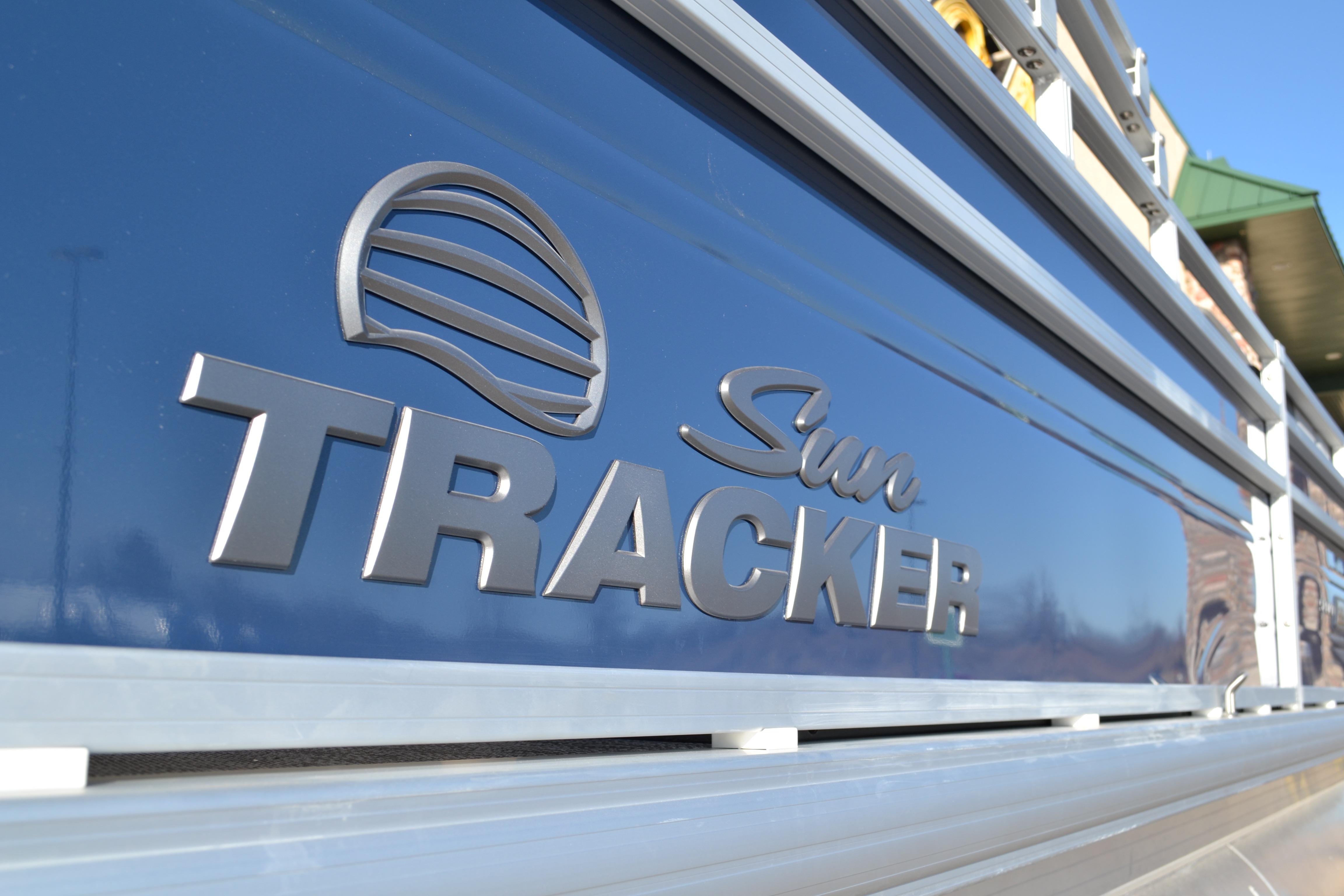 2026 Sun Tracker SportFish 22 XP3 logo on blue boat exterior.