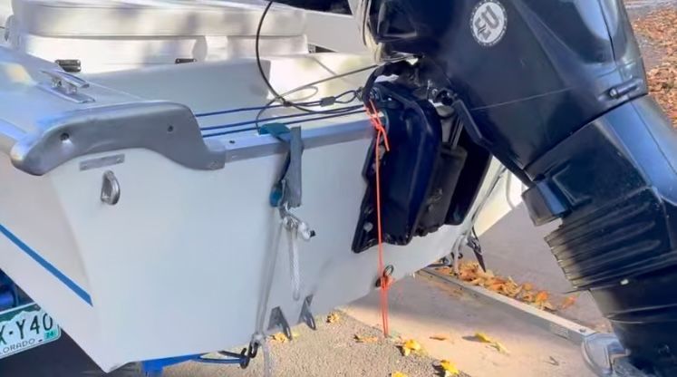 Rear view of a 1962 Larsen 13 boat with outboard motor.