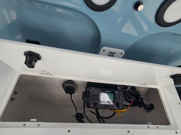 2026 Sea Hunt BX 22 BR boat console with radio equipment and storage compartment.