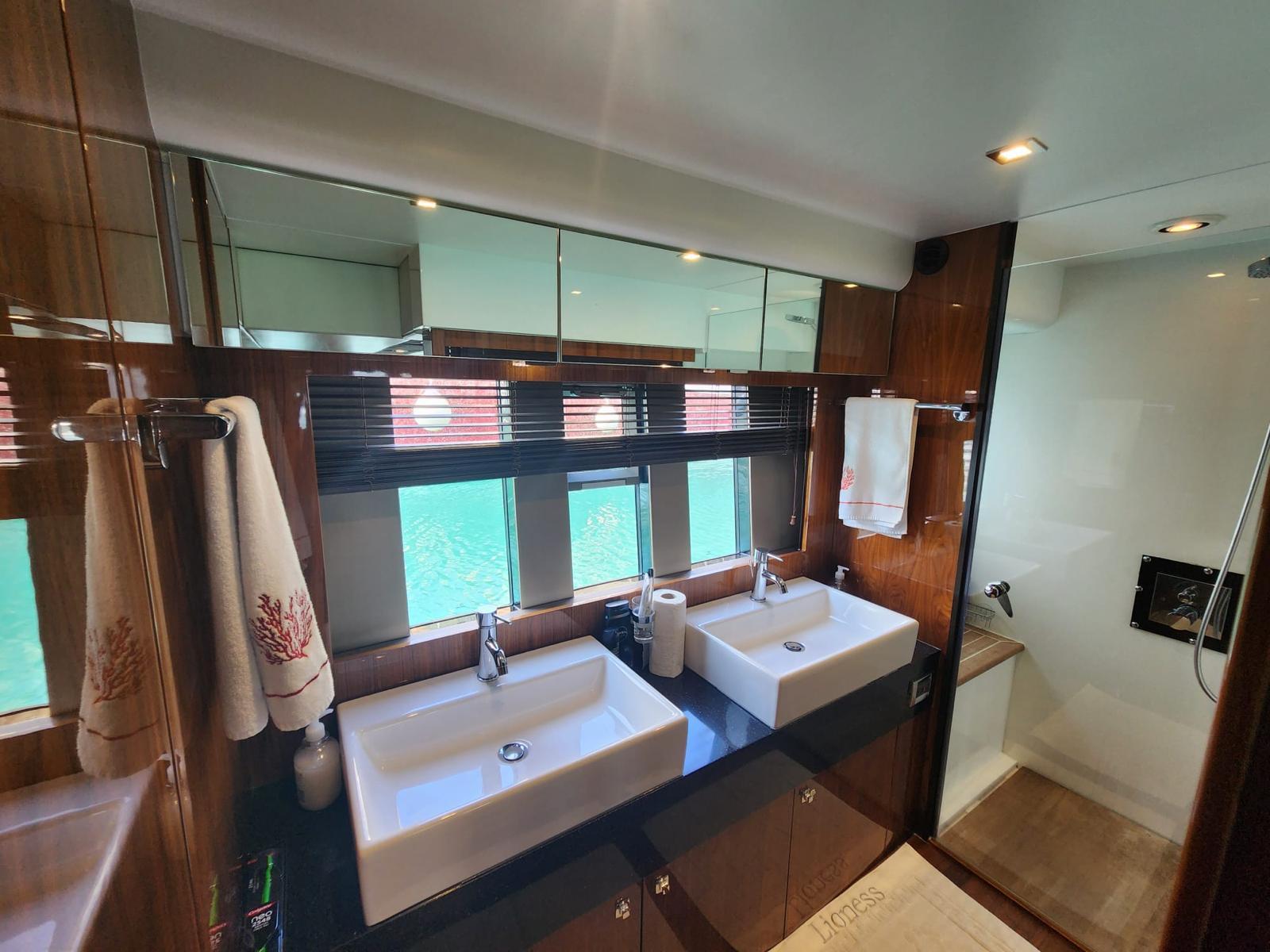Luxurious bathroom in 2012 Fairline Squadron 65 yacht with dual sinks and modern fixtures.