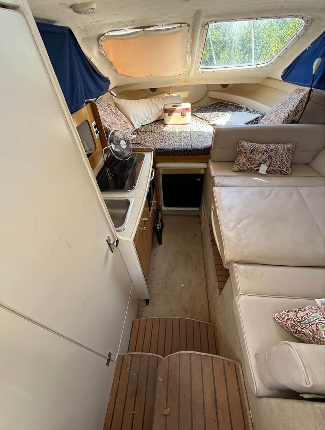 Interior of a 2003 Bayliner 2452 Classic Cruiser with kitchen and seating area.