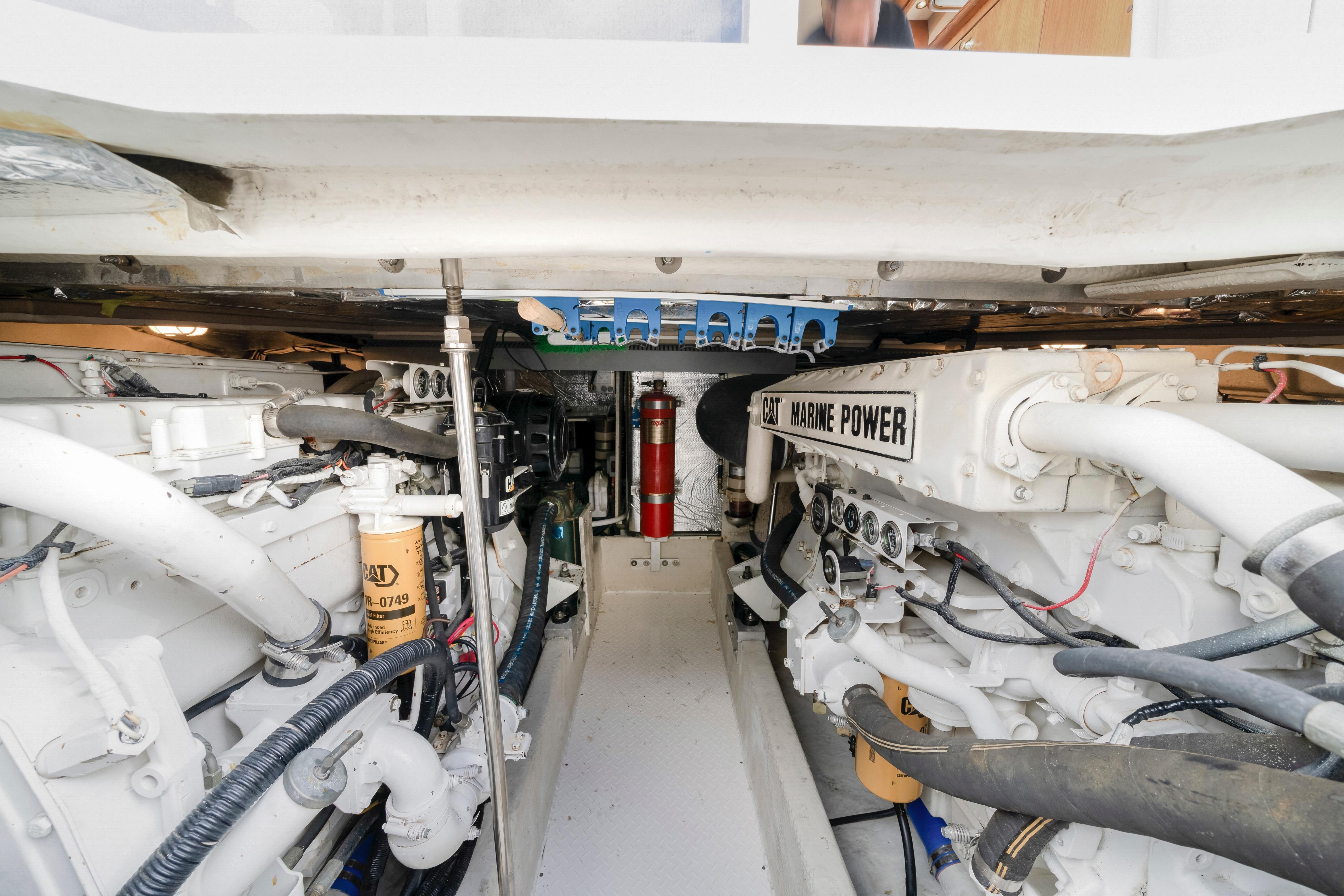 Engine room of 2001 Cruisers Yachts 5000 Sedan Sport, featuring CAT Marine Power engines.