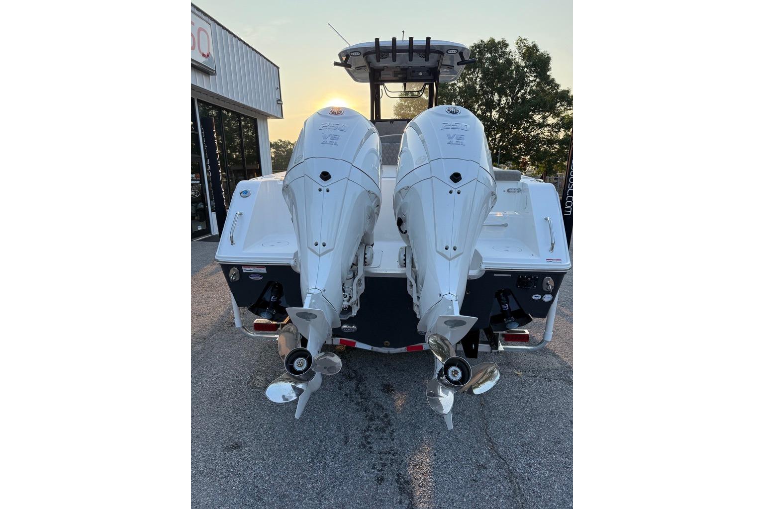 2026 Sea Hunt Gamefish 27 Coffin Box with dual outboard engines, rear view.