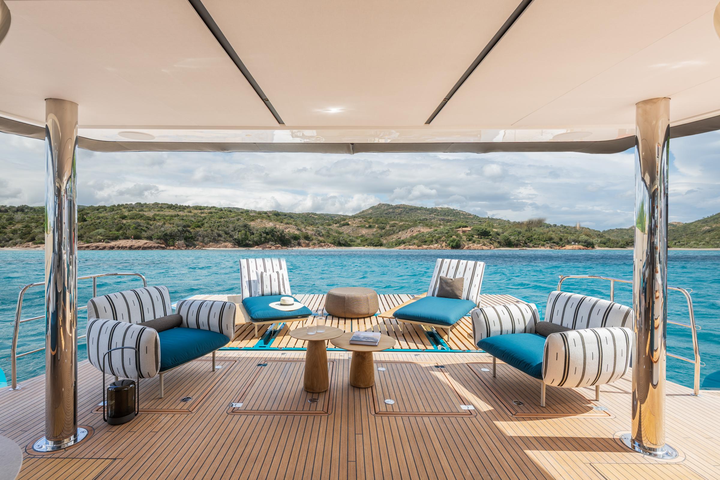 Luxurious Lagoon Eighty 2 yacht deck with stylish seating, overlooking serene blue waters, 2025 model.