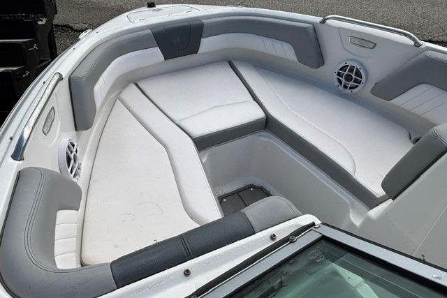 2021 Chaparral 21 SSi boat interior with gray and white seating, featuring speakers.