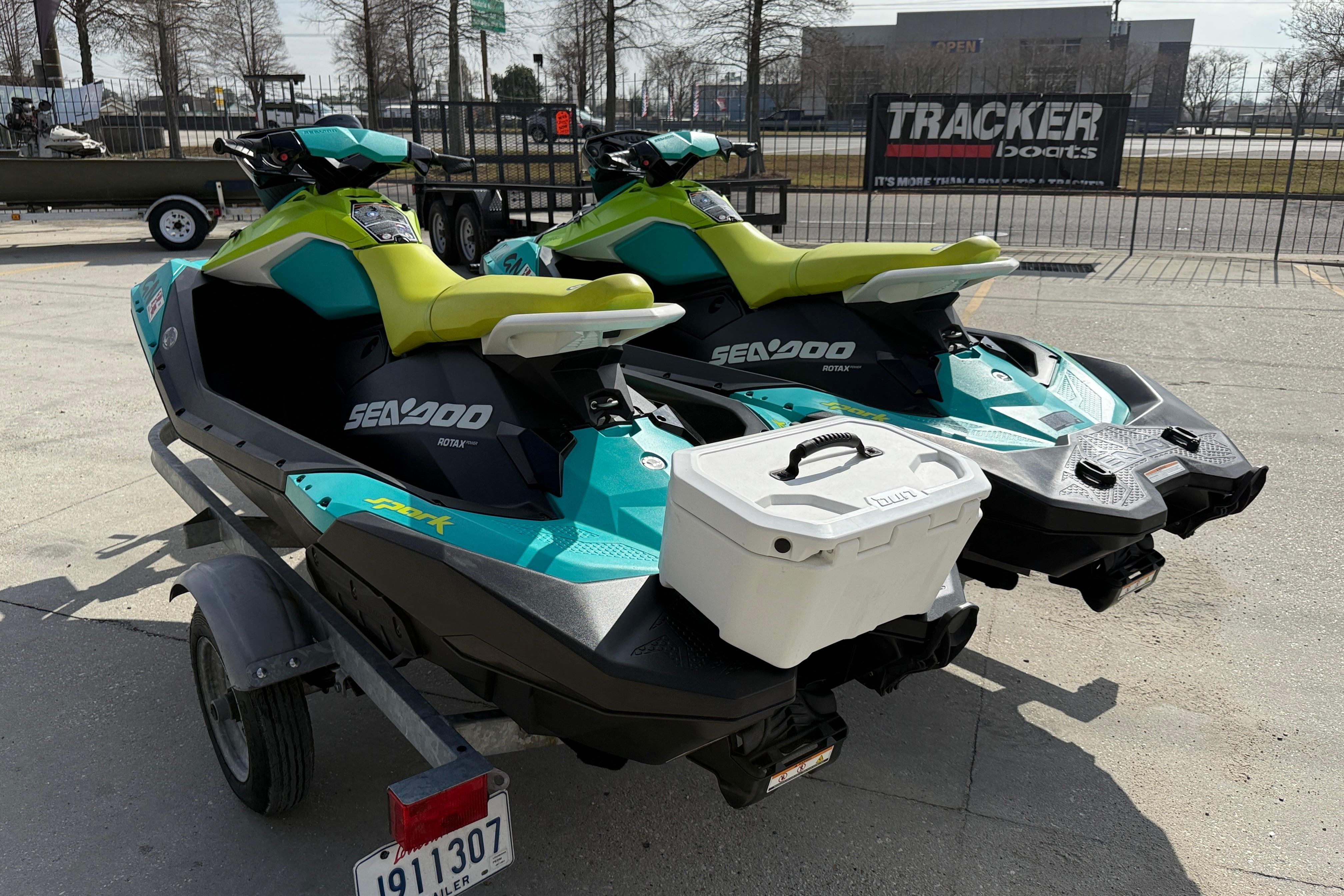 2022 Sea-Doo Spark 3up jet skis on trailer, parked outdoors.