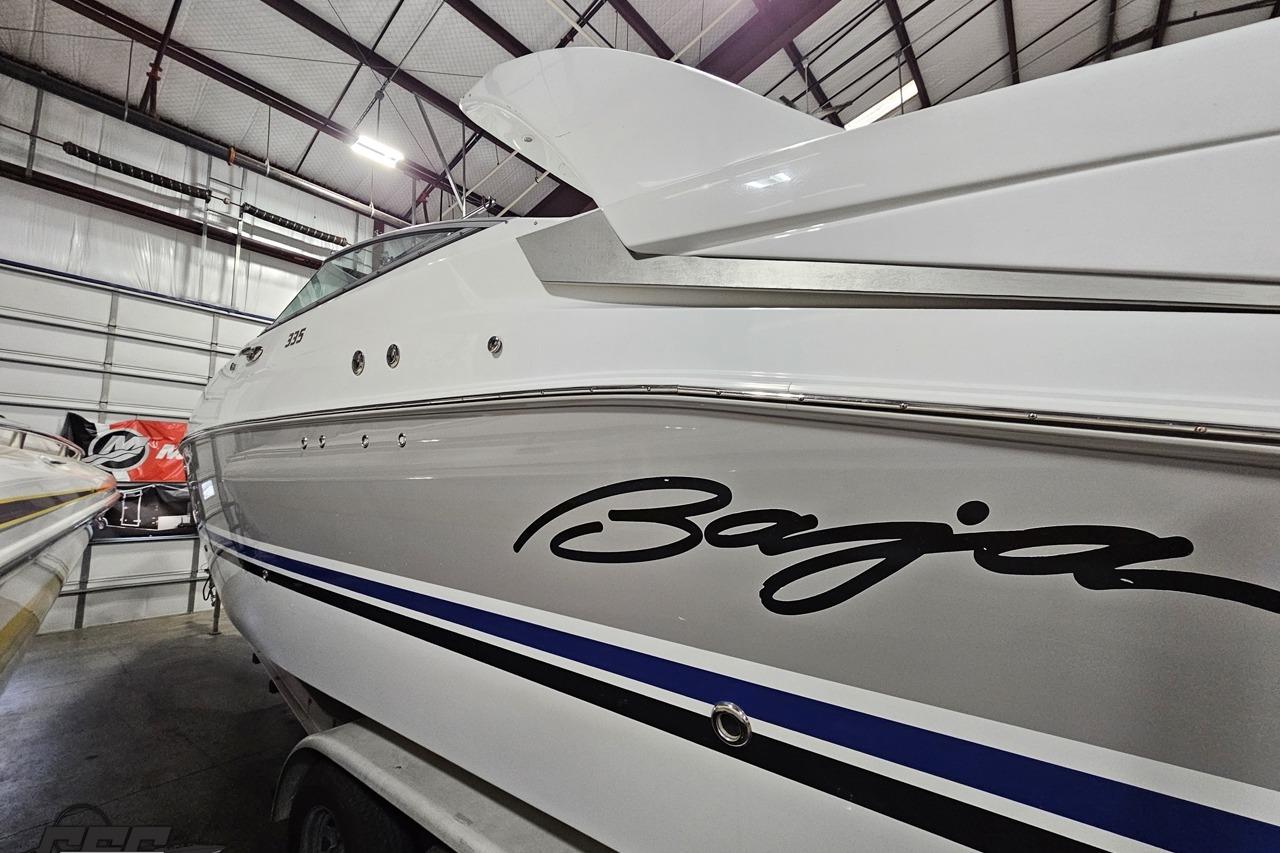 2008 Baja 335 Performance boat in storage, showcasing sleek design and branding.