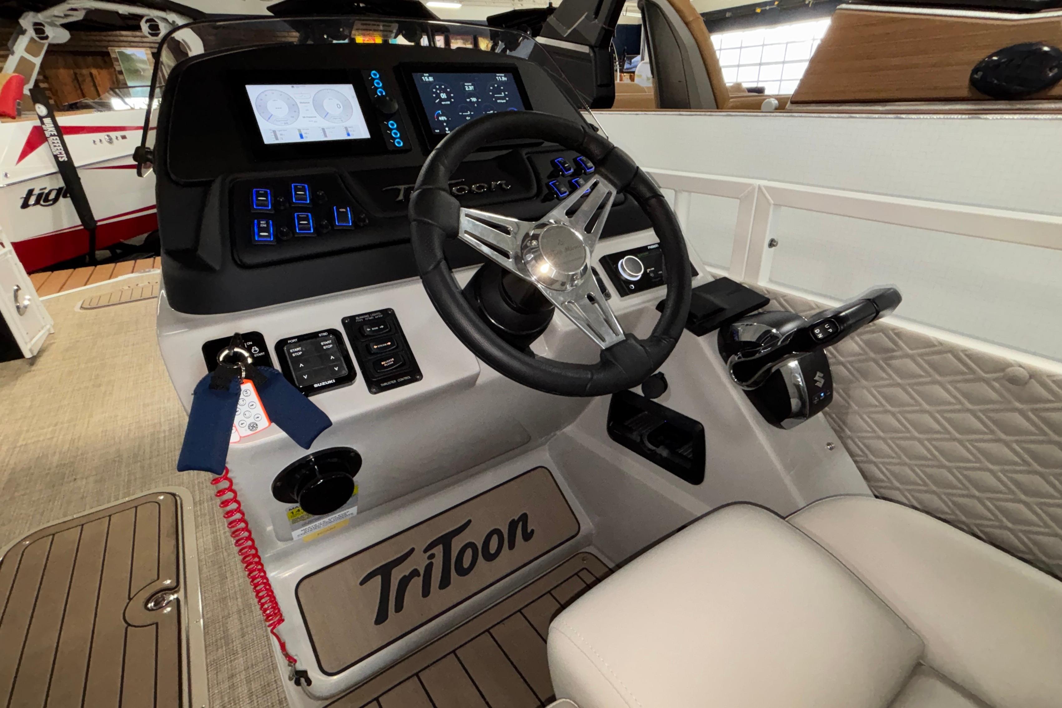 2026 JC Sporttoon 26TT boat dashboard with steering wheel and control panel.