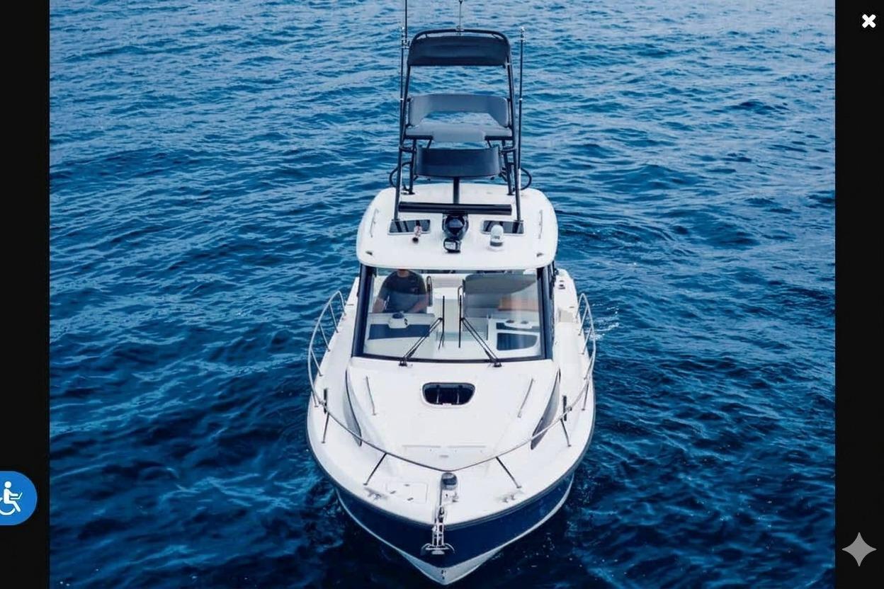 2022 Boston Whaler 325 Conquest boat on open blue sea, aerial view.