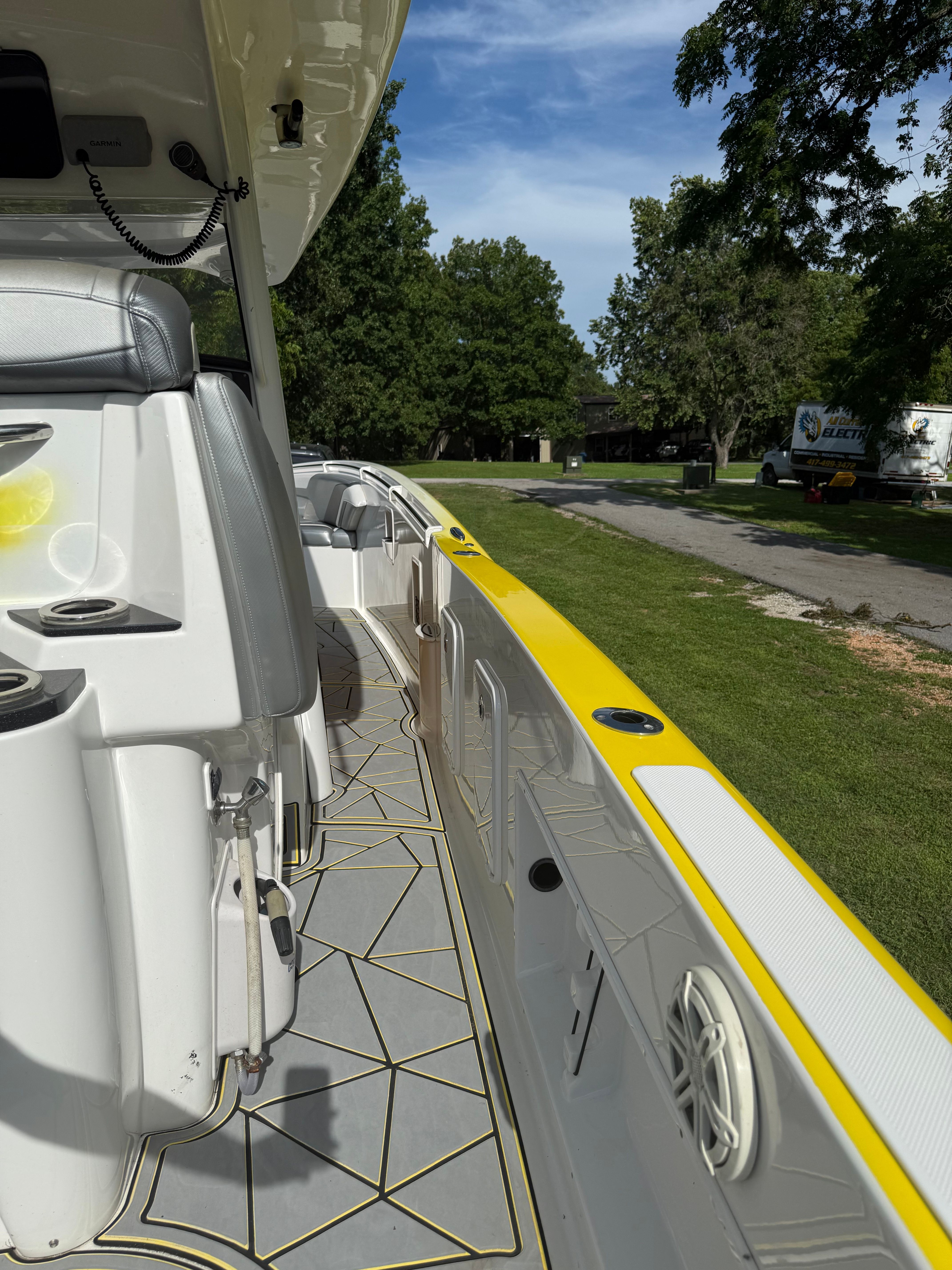 The image shows the deck of a 2014 Sunsation 34 CCX boat with yellow accents.