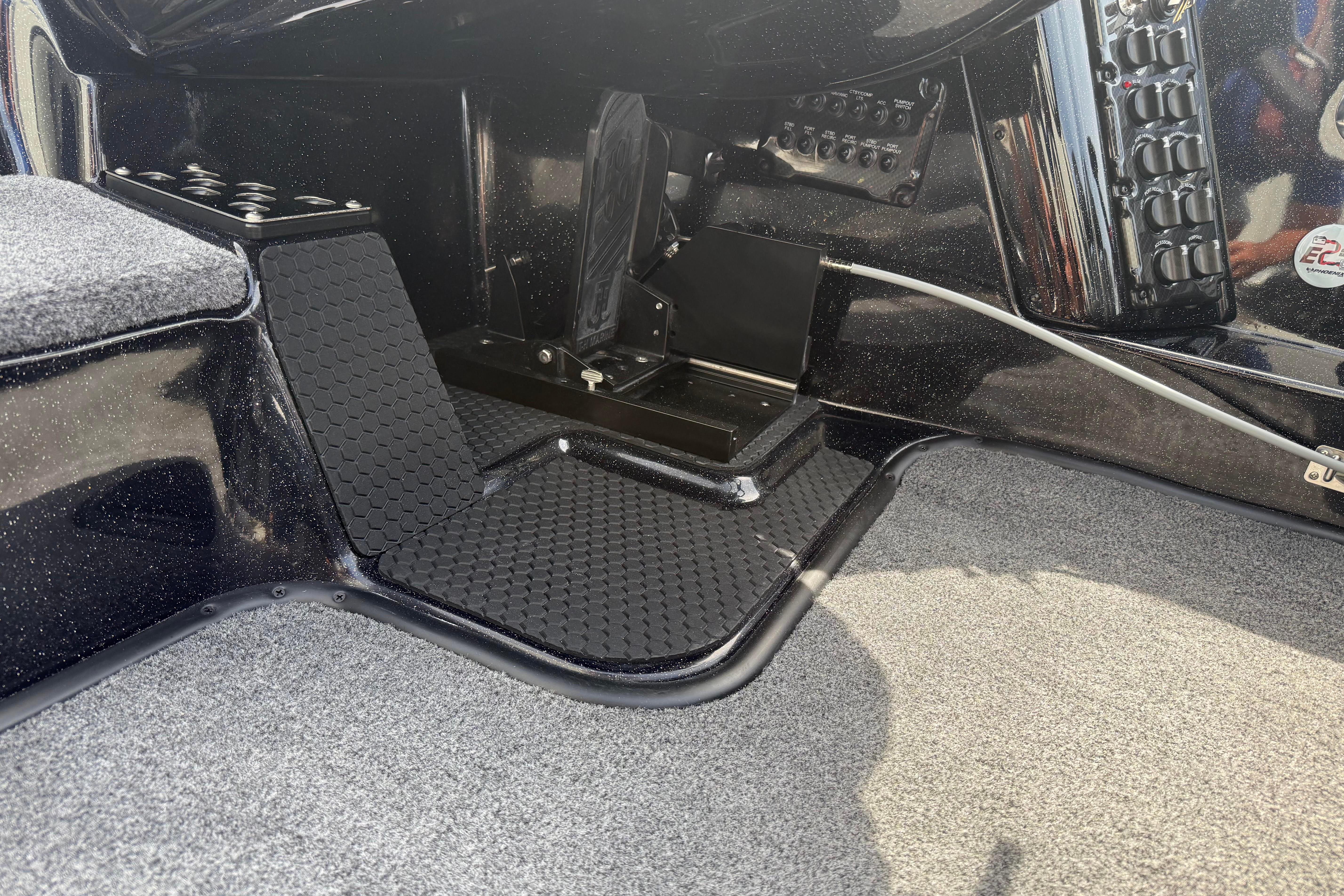 Interior of 2027 Phoenix 921 Elite X boat, featuring sleek black design and control panel.