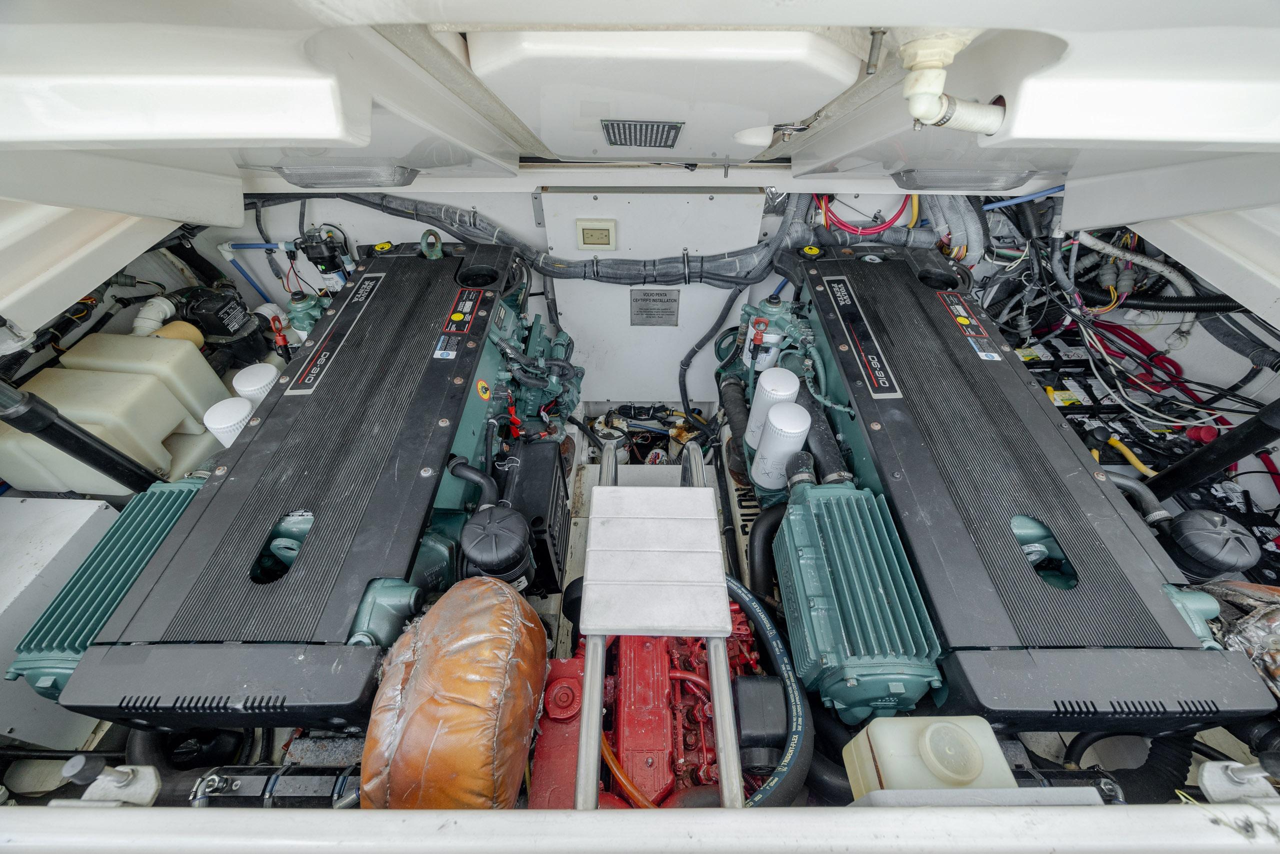 Engine room of a 2004 Tiara Yachts 3200 Open, showcasing dual engines and components.
