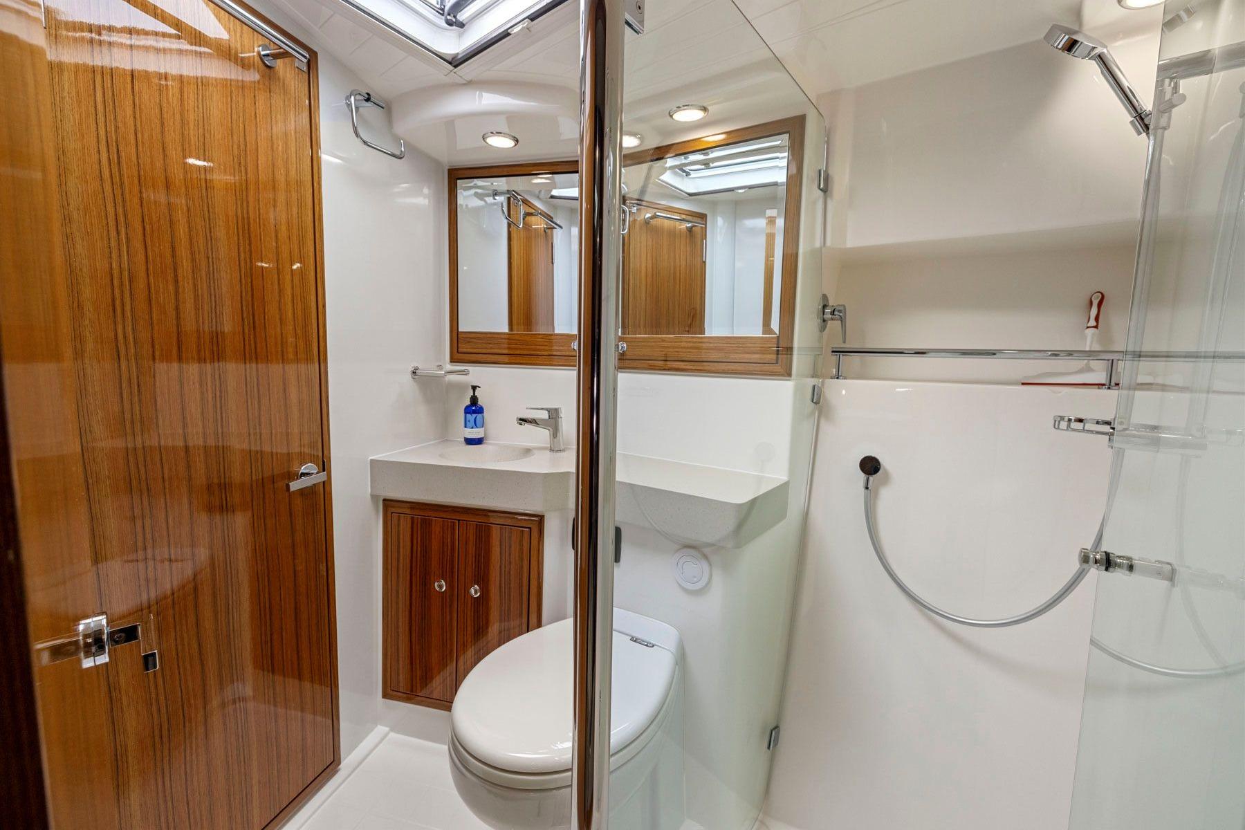 Luxurious bathroom in 2014 Maritimo M50 yacht with wood accents and modern fixtures.