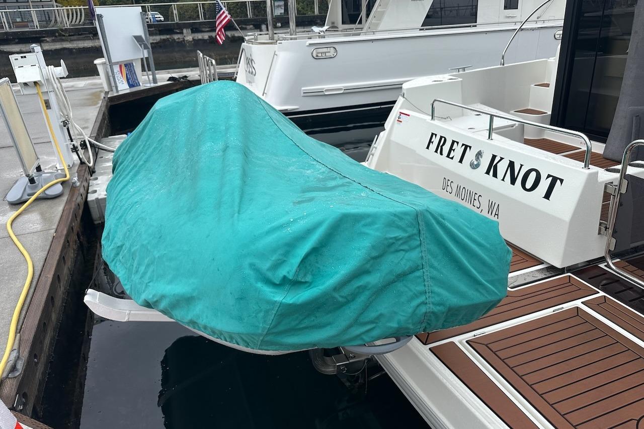 2024 Beneteau Swift Trawler 41 Sedan docked, covered dinghy, Des Moines, WA.