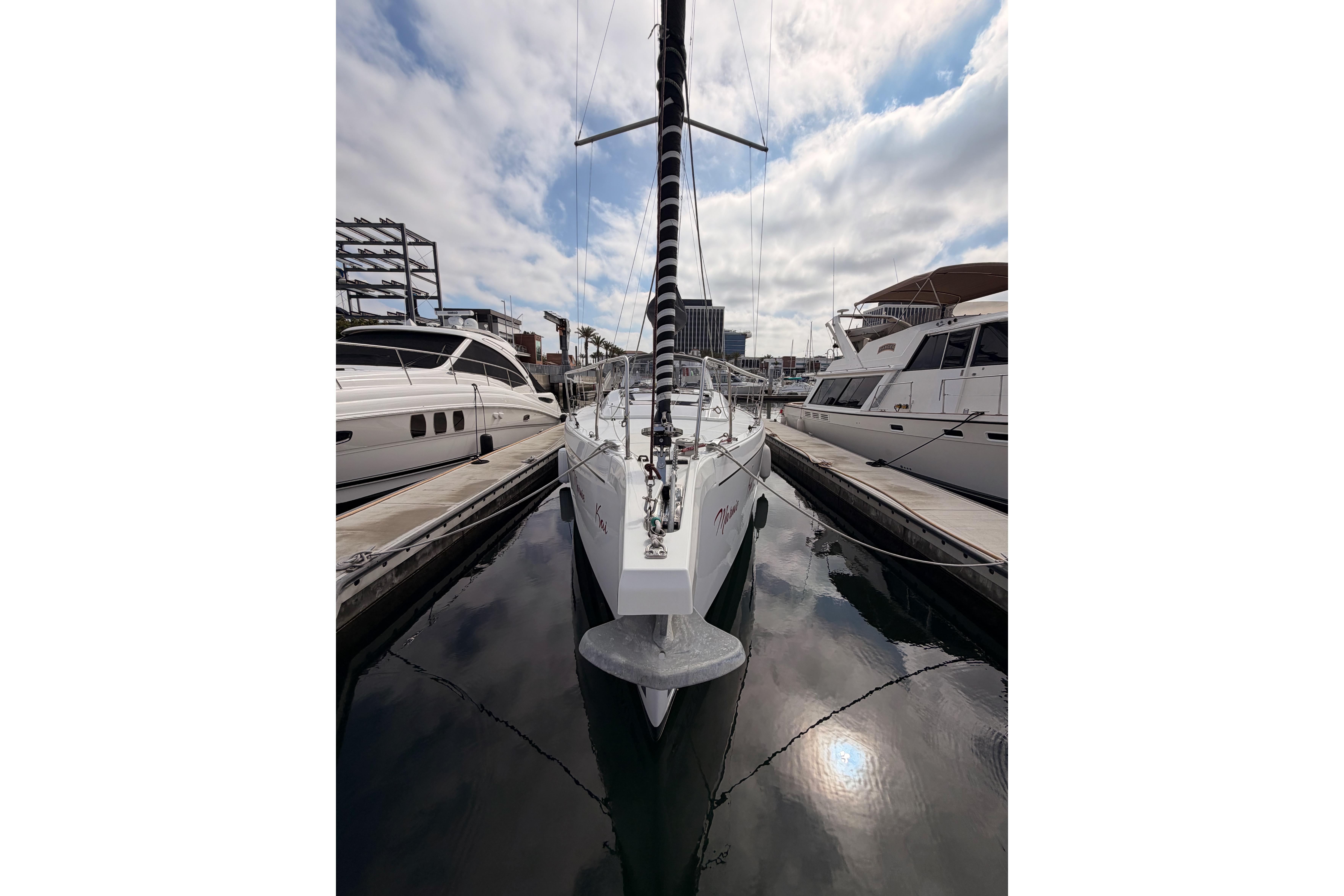 2020 Beneteau Oceanis 46.1 yacht docked at marina under cloudy sky.