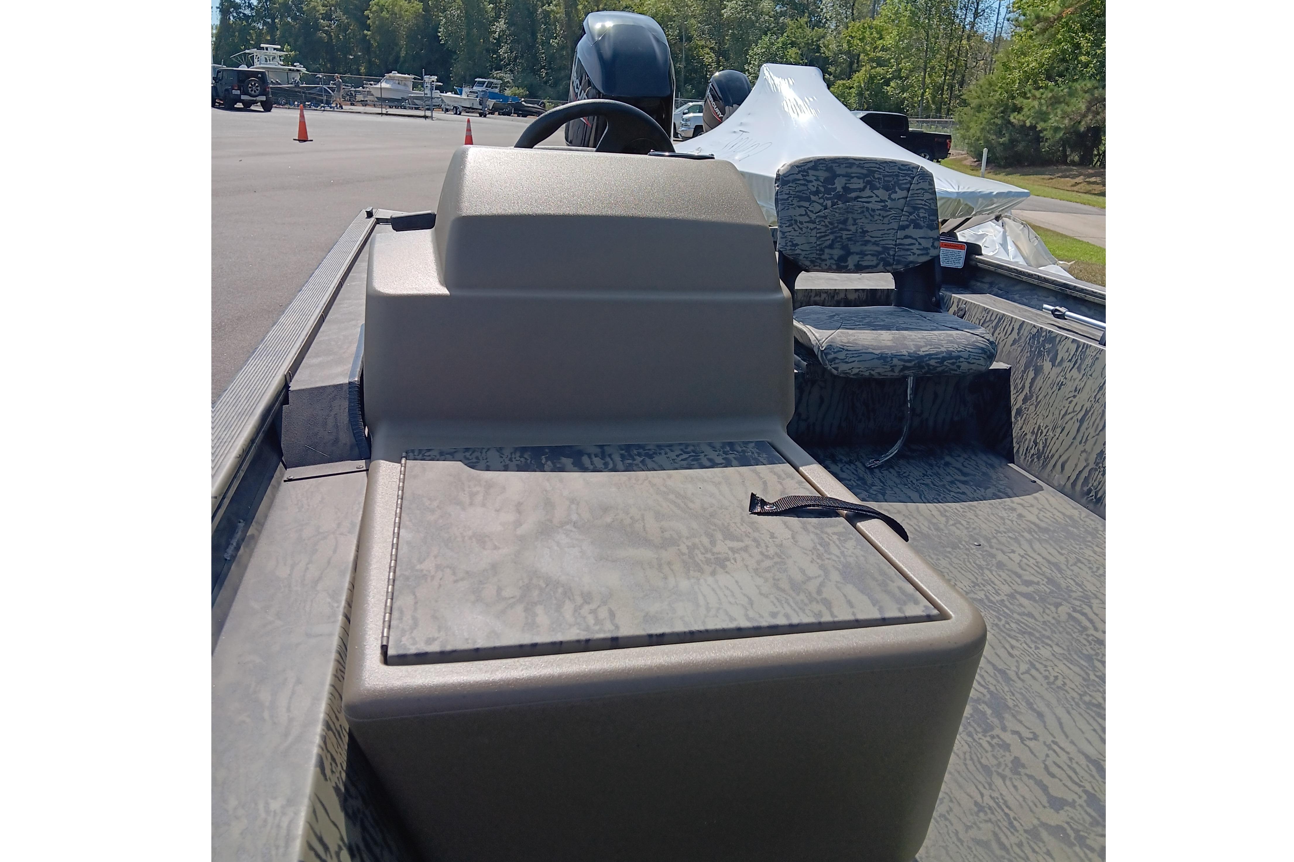 2026 Tracker Grizzly 1754 SC boat interior with camo seating and steering console.