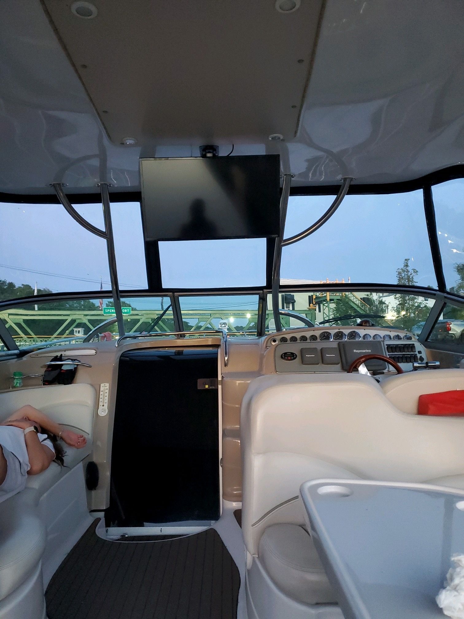 Interior of a yacht with steering console and seats, view through the windshield.