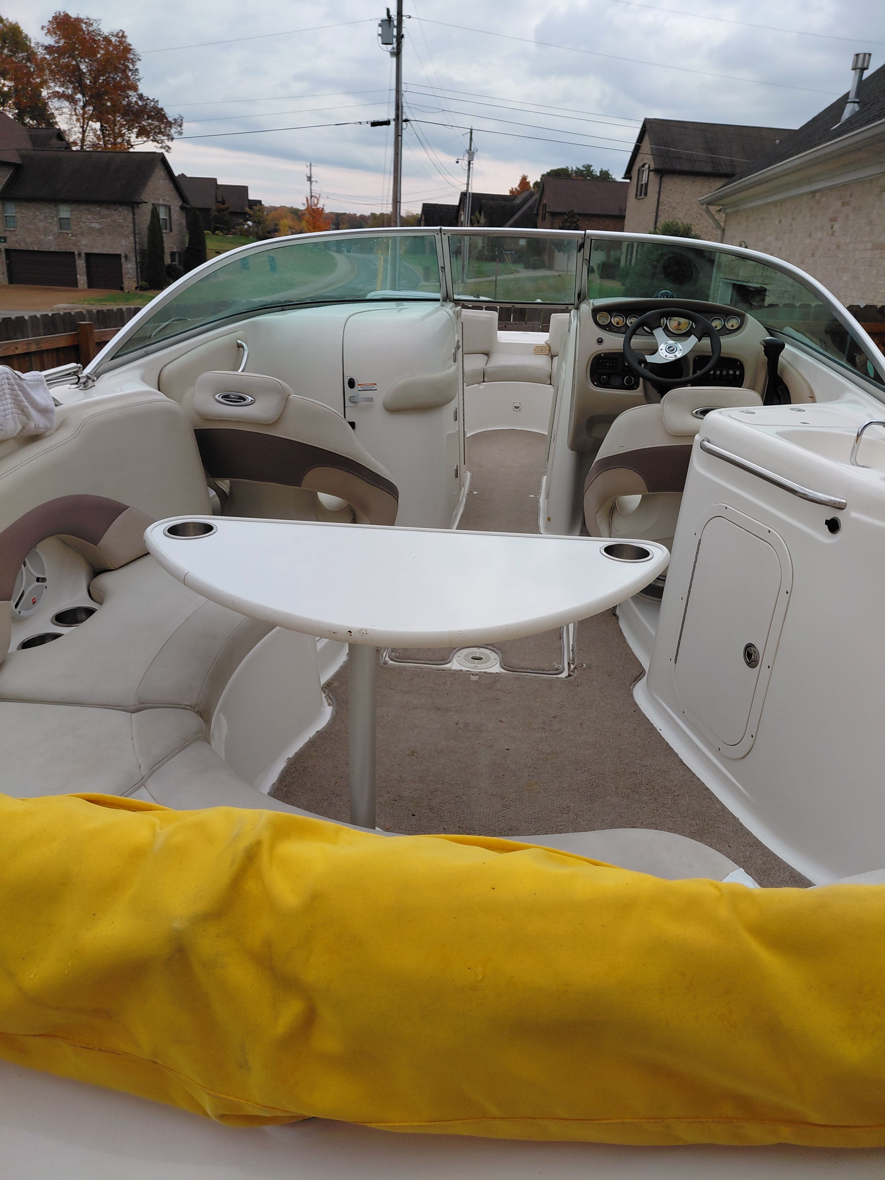 Interior of a 2005 Chaparral Sunestra 254 boat with table and seating.