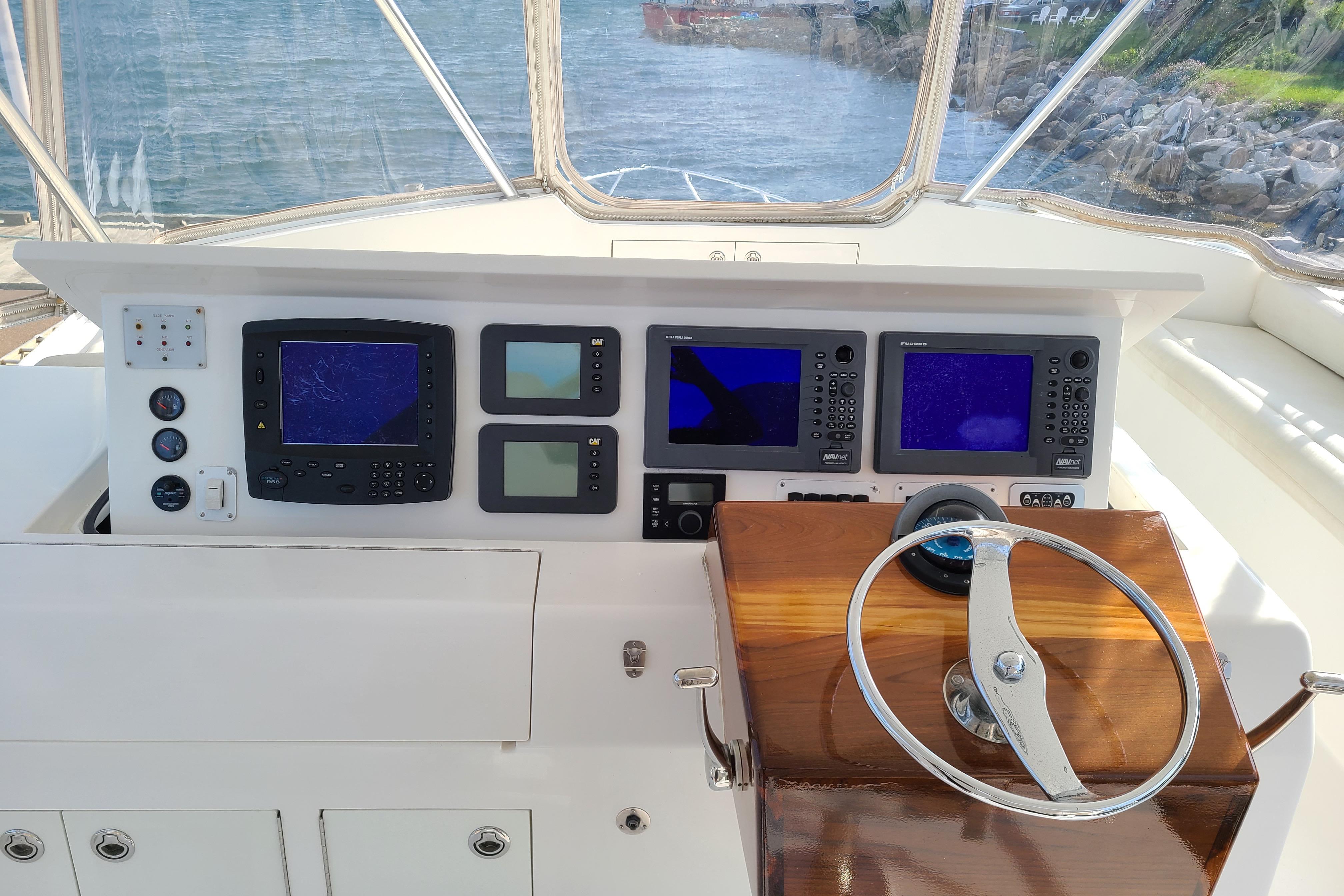 Helm of 2006 Egg Harbor 50 Sport Yacht with navigation instruments and steering wheel.