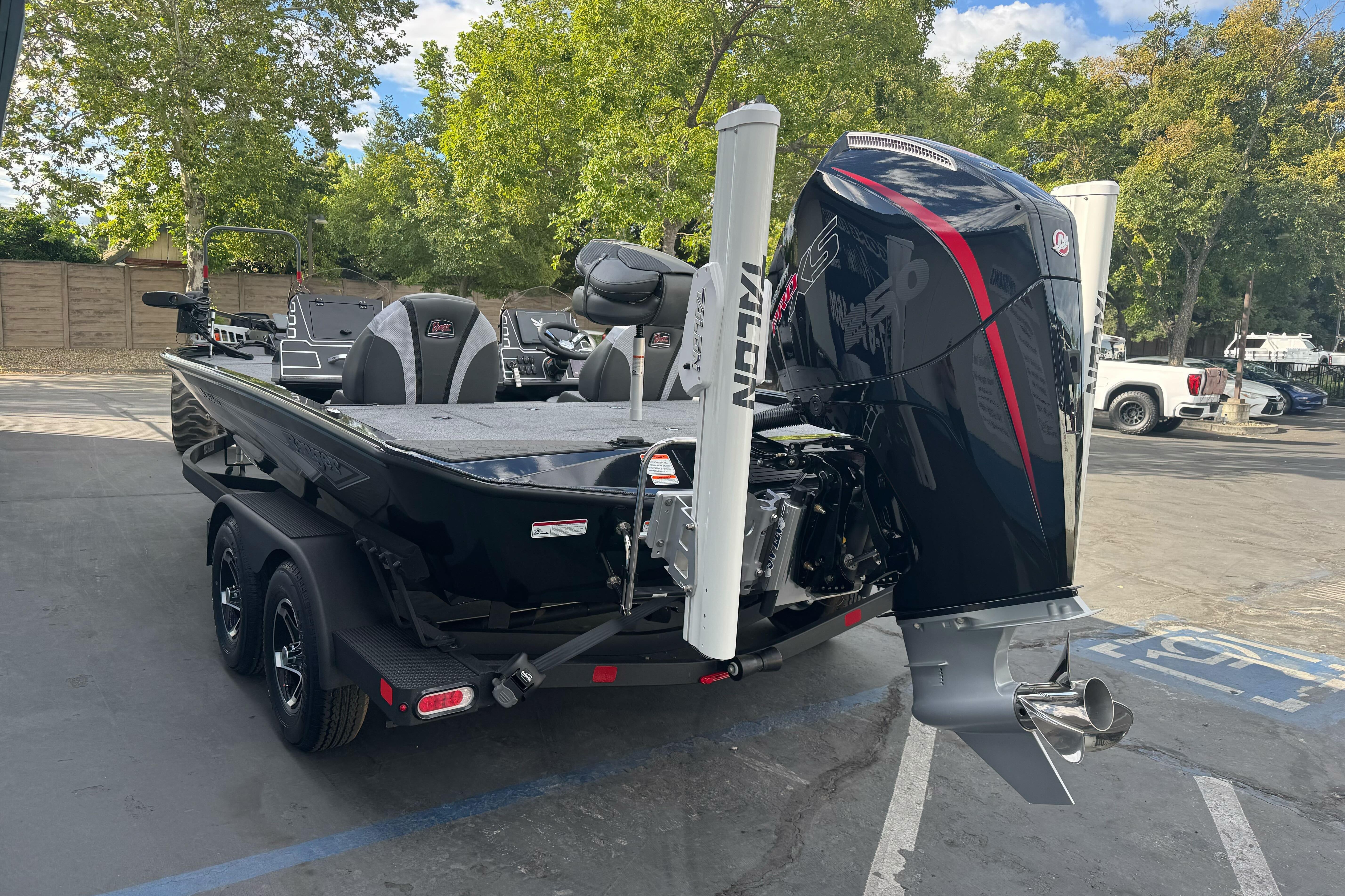 2026 Ranger ALPHA 208 boat with powerful outboard motor in a parking lot.