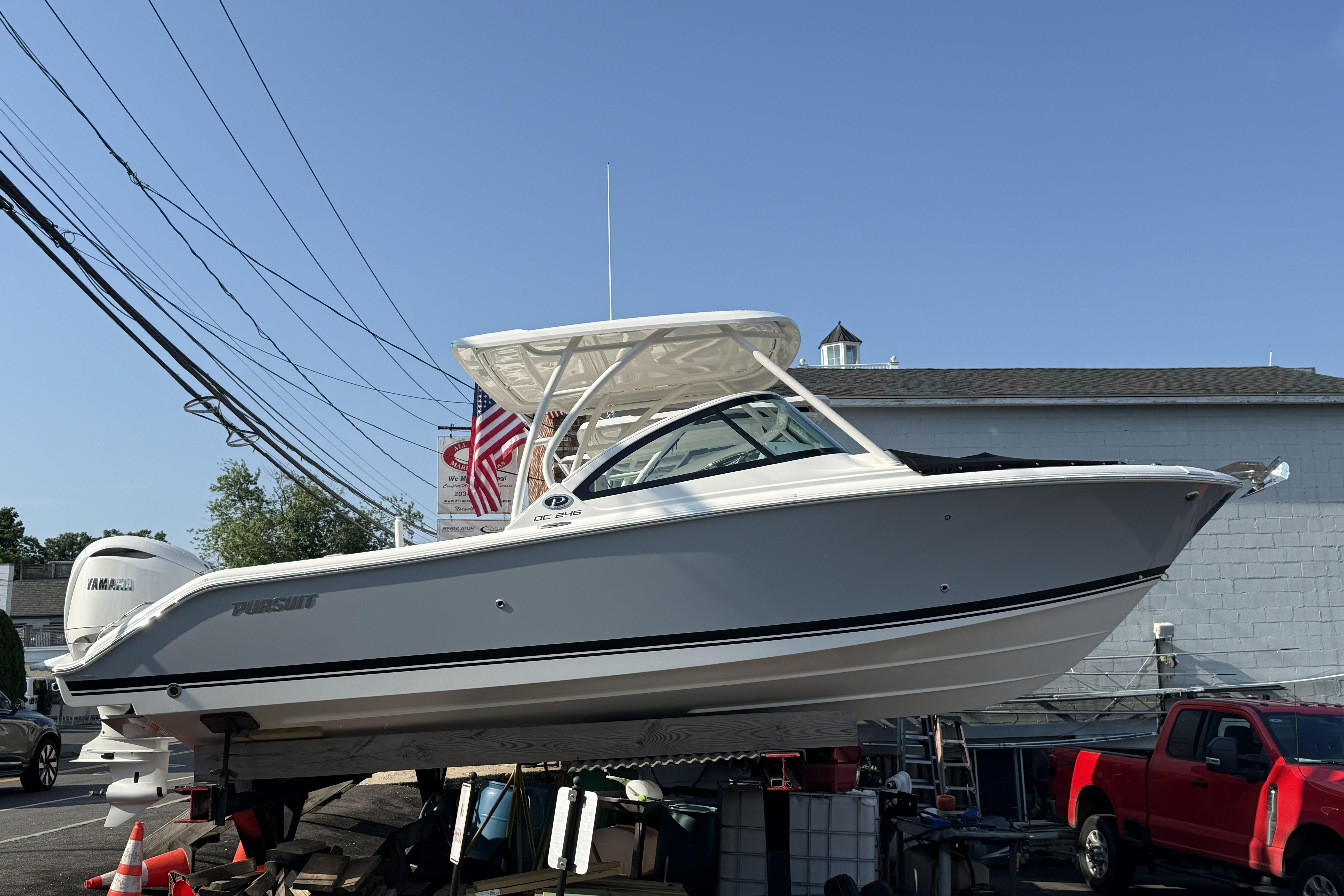 2027 Pursuit DC 246 Dual Console boat displayed outdoors on a sunny day.