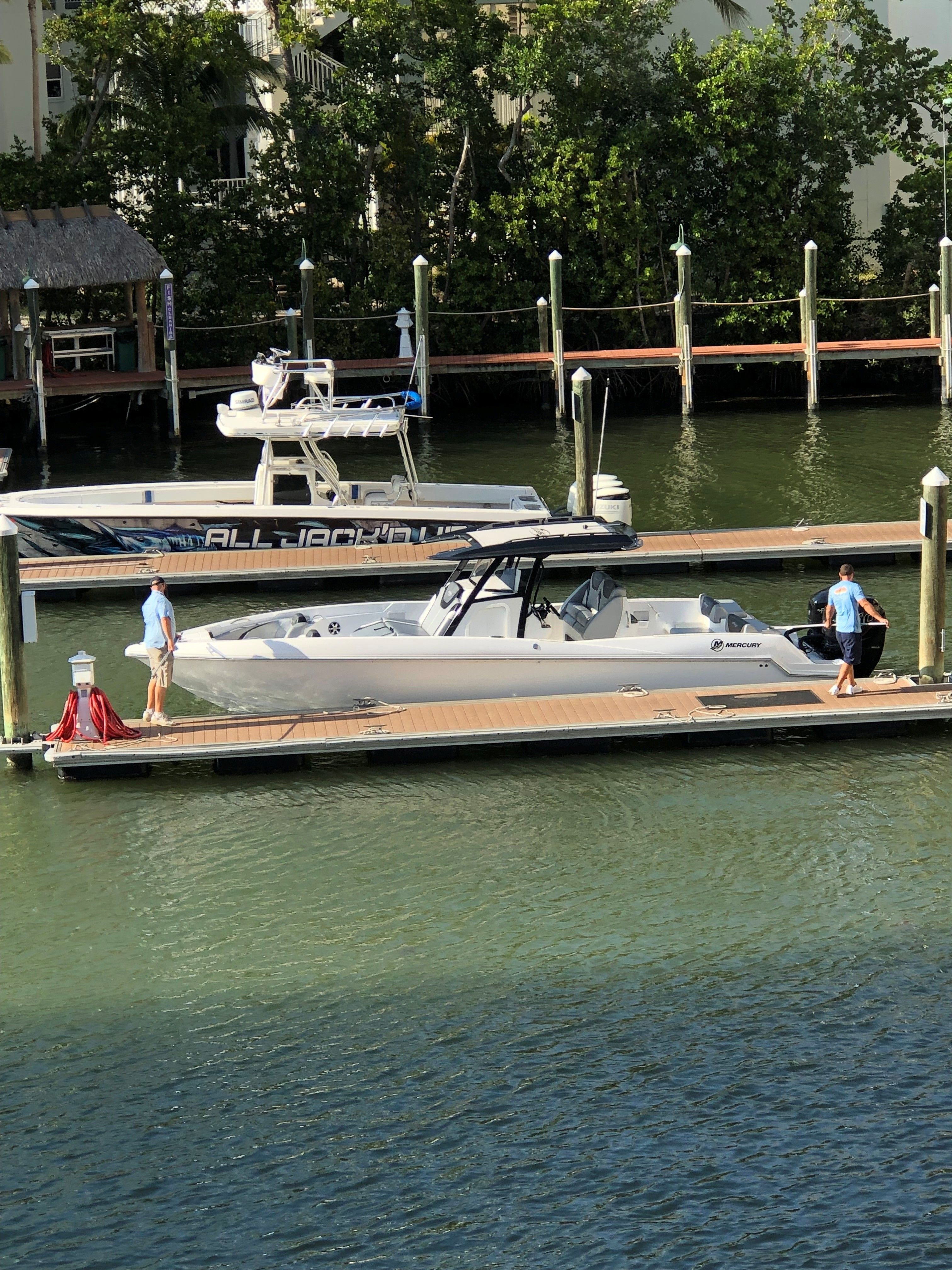 2017 Sunsation 32 CCX boat docked with two people onboard.