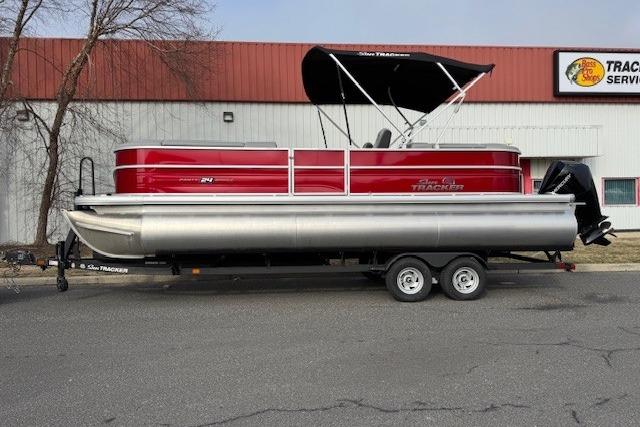2026 Sun Tracker Party Barge 24 XP3 pontoon boat on trailer, red and silver design.