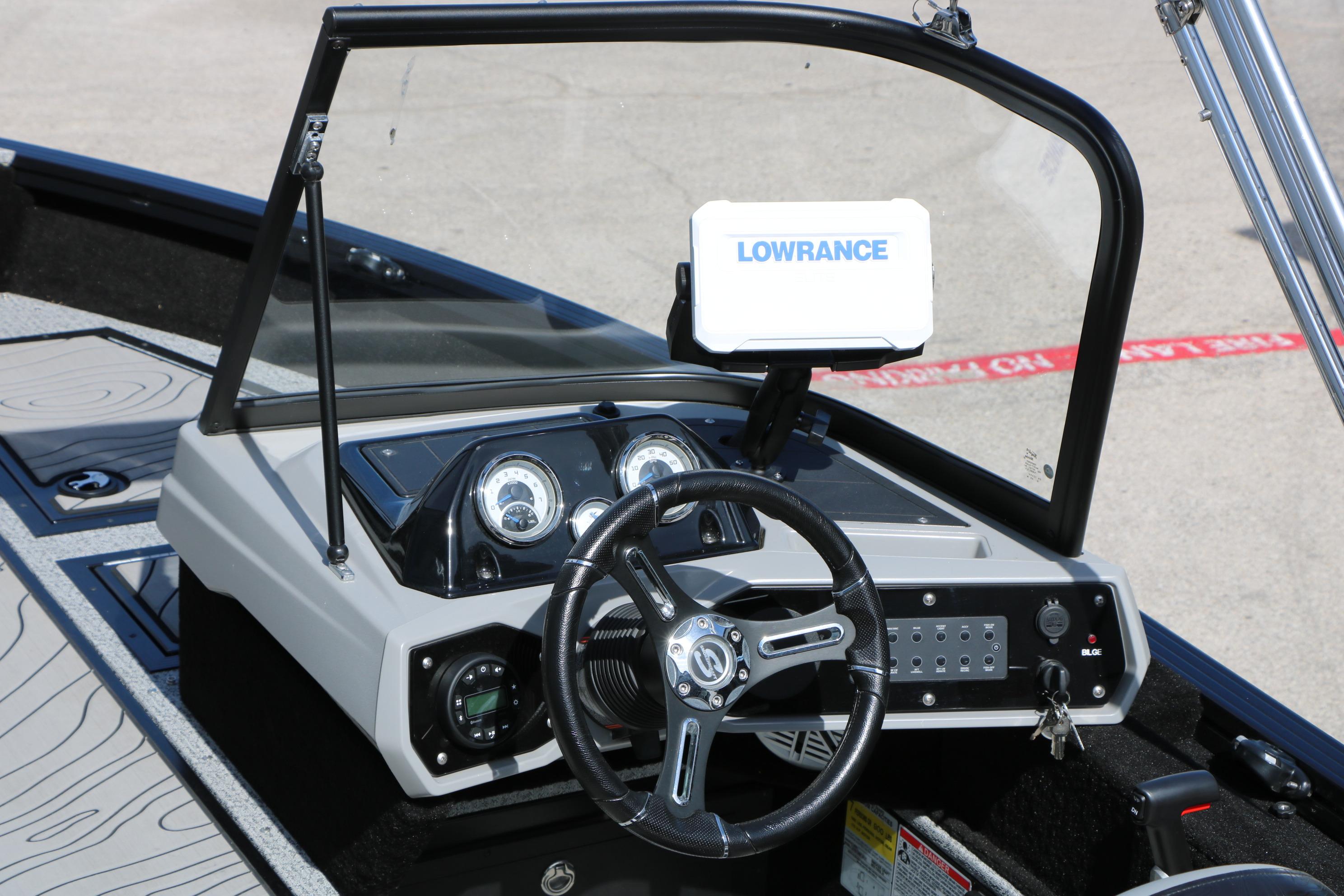 2025 Smoker Craft Adventurer 188 DC boat dashboard with steering wheel and Lowrance display.