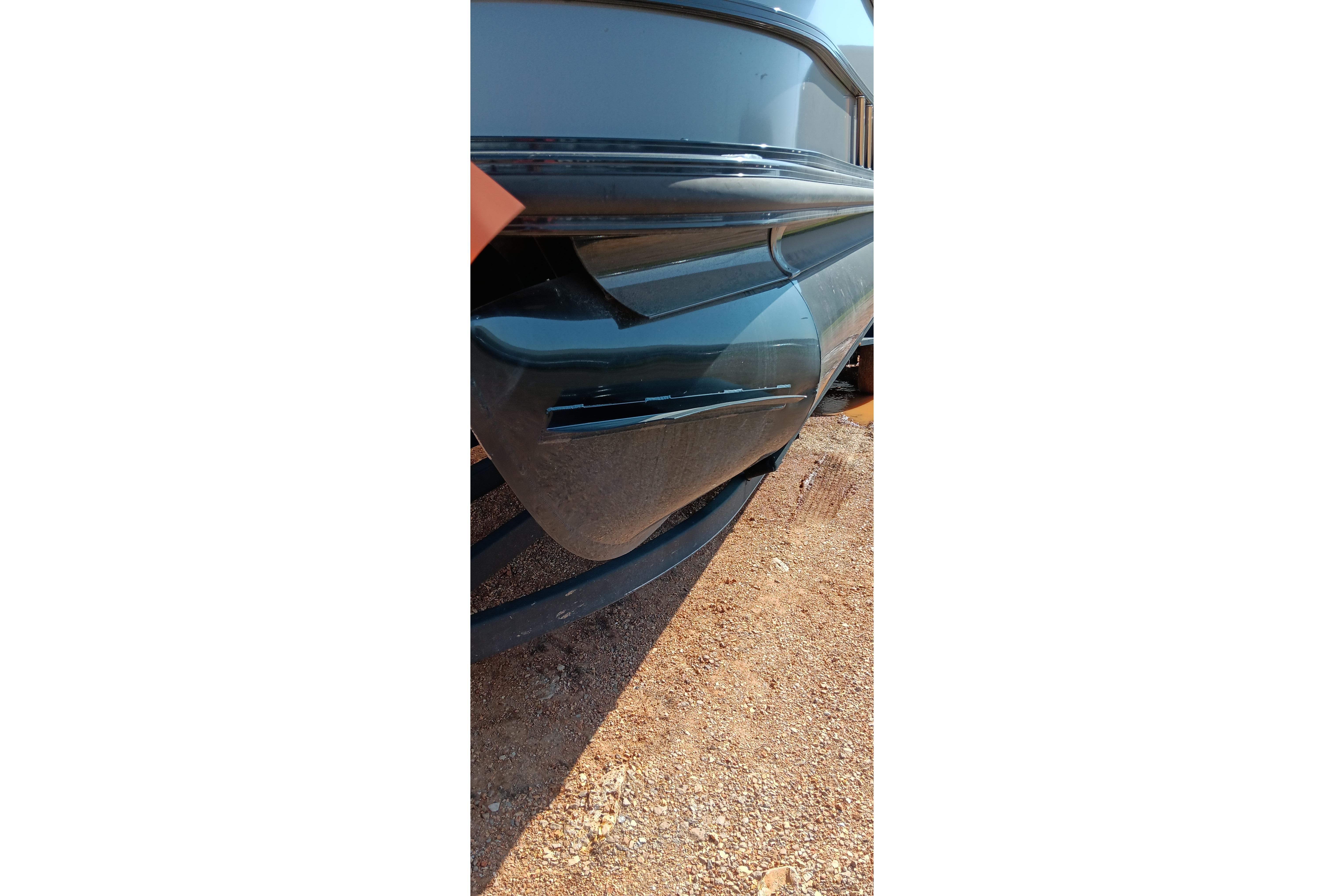 Close-up of a 2023 Ranger 2500LS boat hull on a gravel surface.