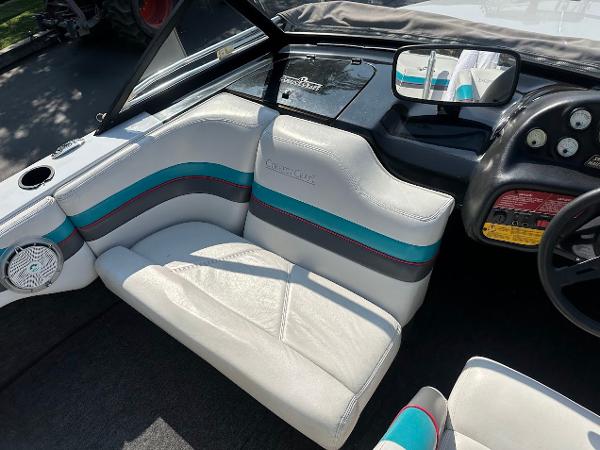 1992 Correct Craft Ski Nautique interior with white and teal seating, dashboard, and steering wheel.