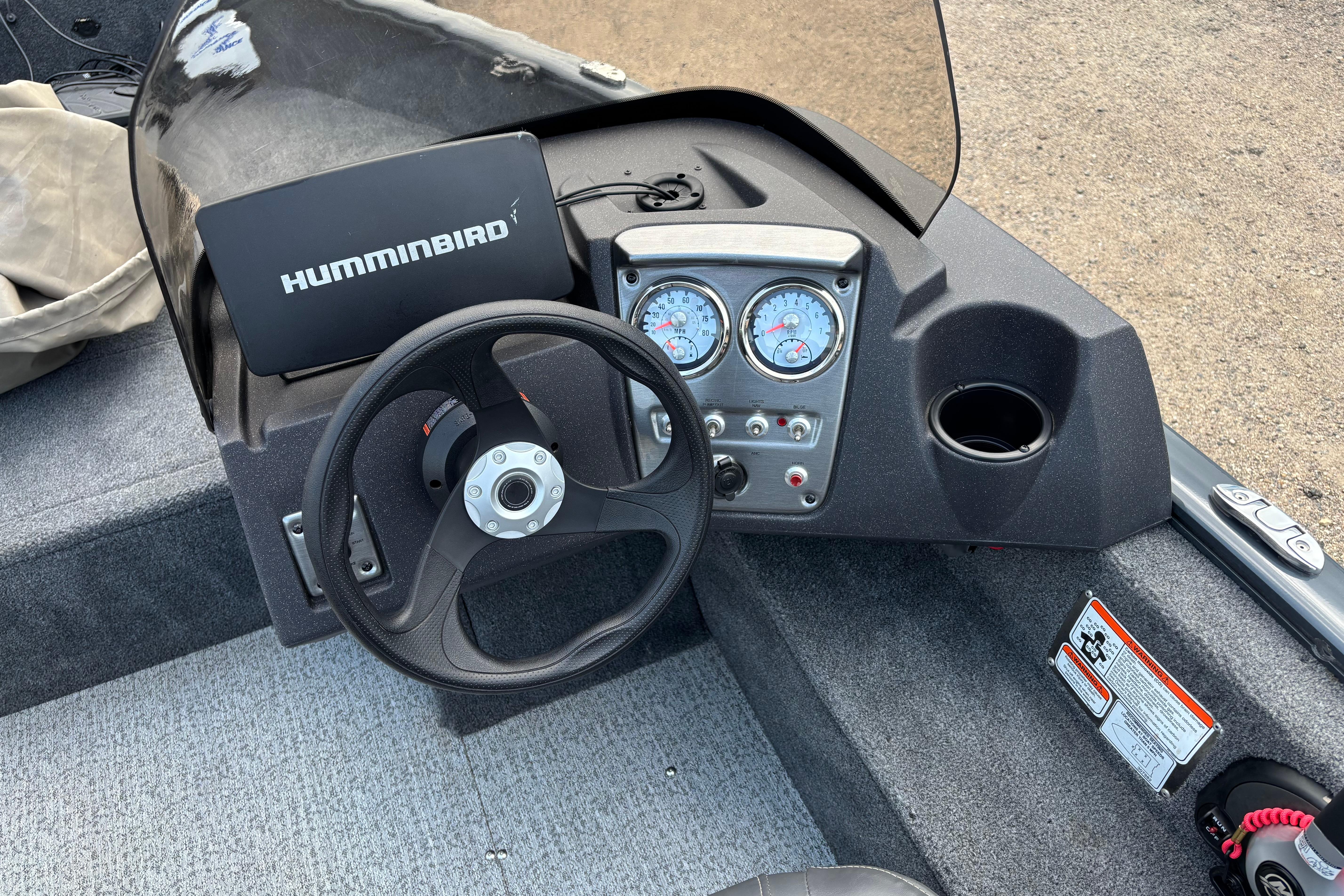 2021 Tracker Pro Guide V-16 WT boat dashboard with steering wheel and Humminbird device.