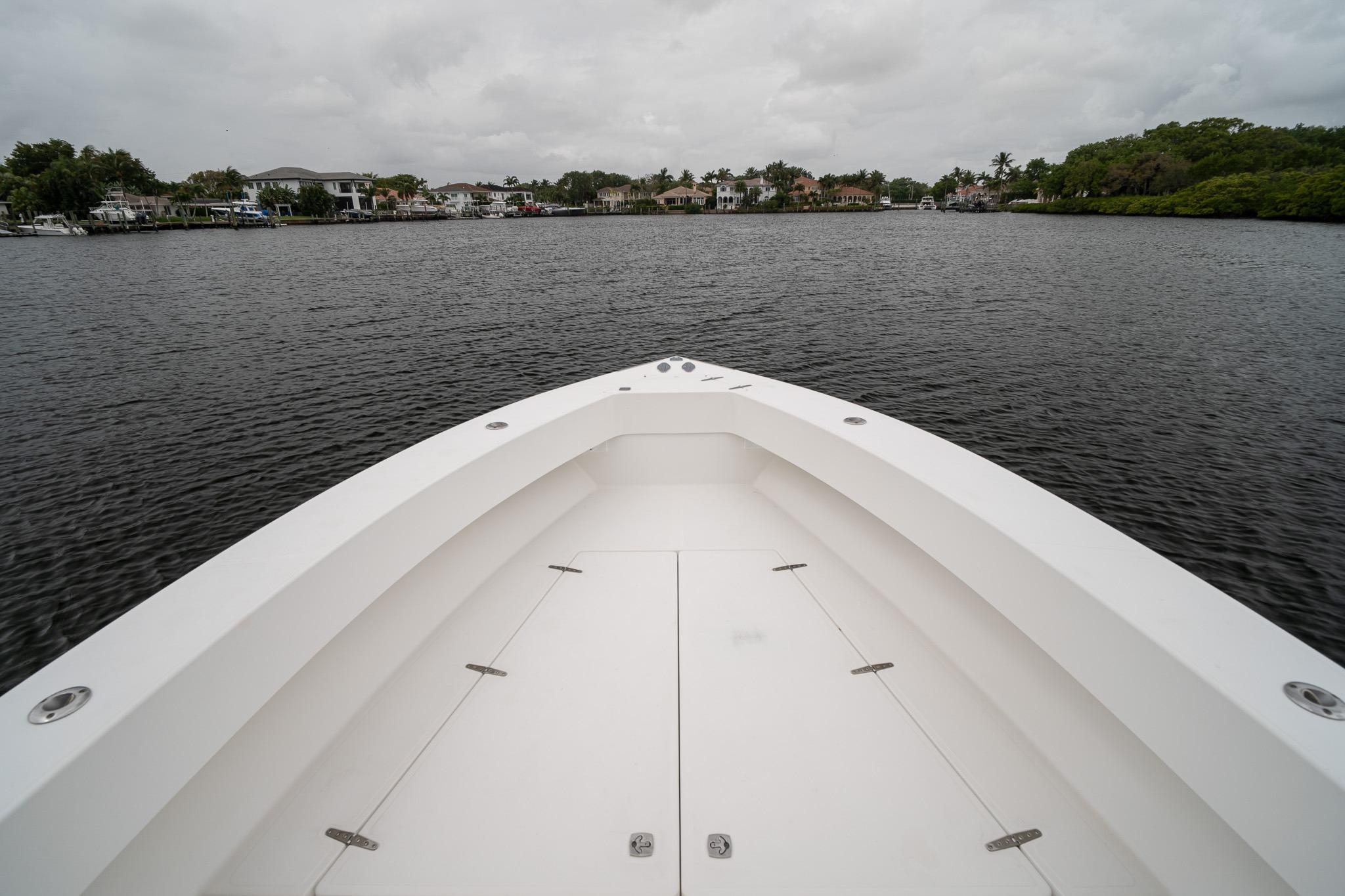 2006 Venture Center Console boat on calm water with cloudy sky.
