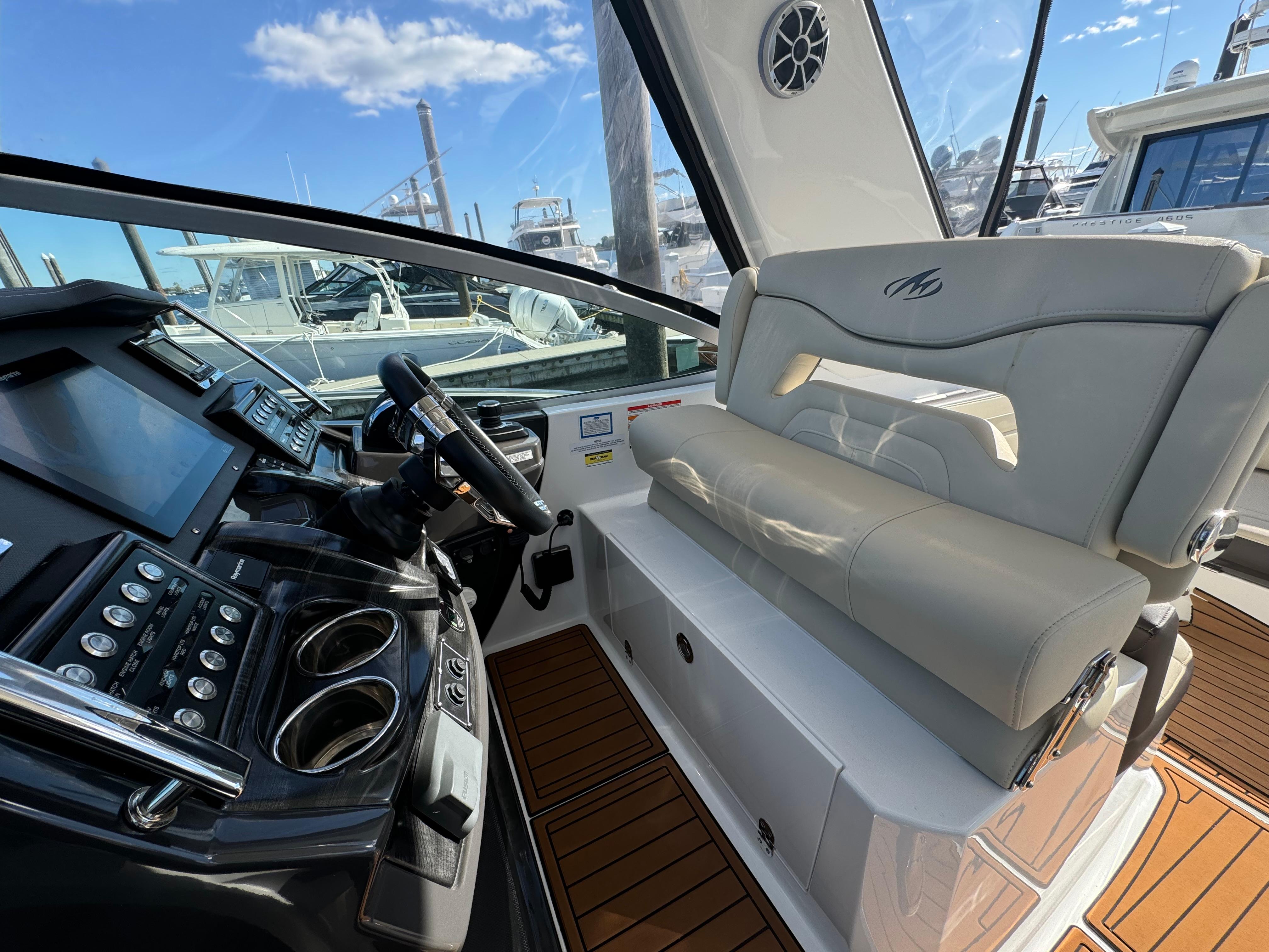 2018 Monterey 335 SY yacht interior with helm, seating, and modern controls.