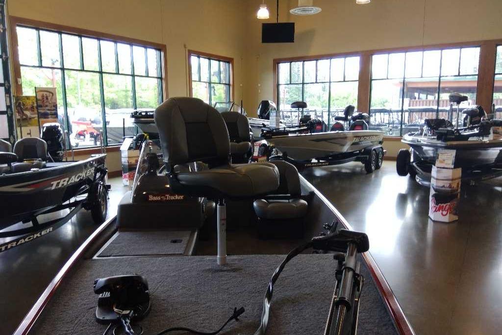 2026 Tracker Bass Tracker Classic XL boat displayed in a showroom with large windows.