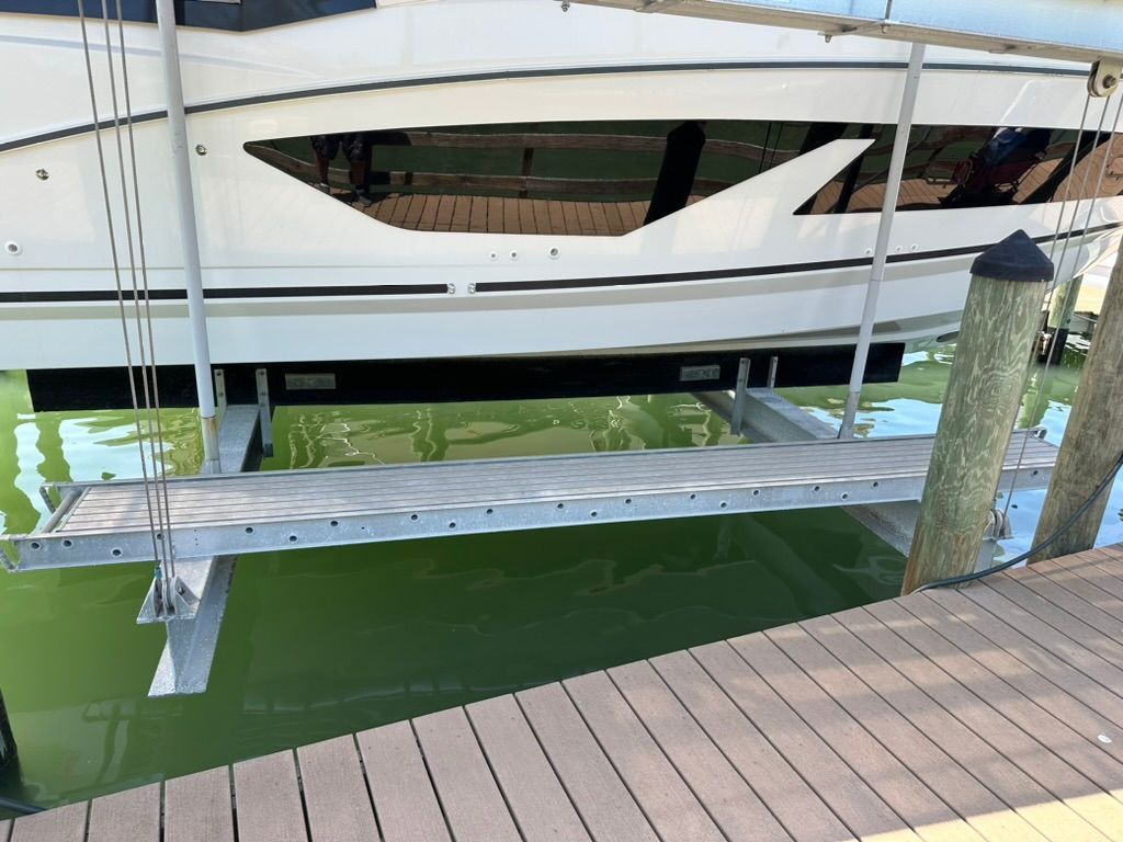 2024 Beneteau Gran Turismo 32 on a boat lift at the dock.