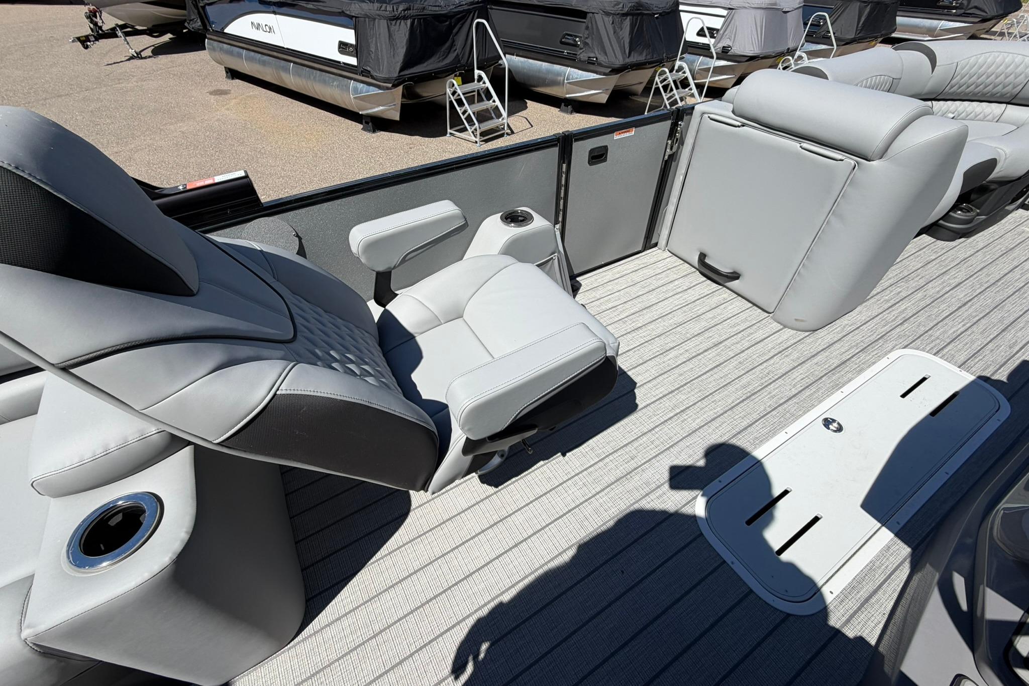 2026 Avalon Catalina Quad Lounge Shift boat interior with luxurious gray seating and cup holders.