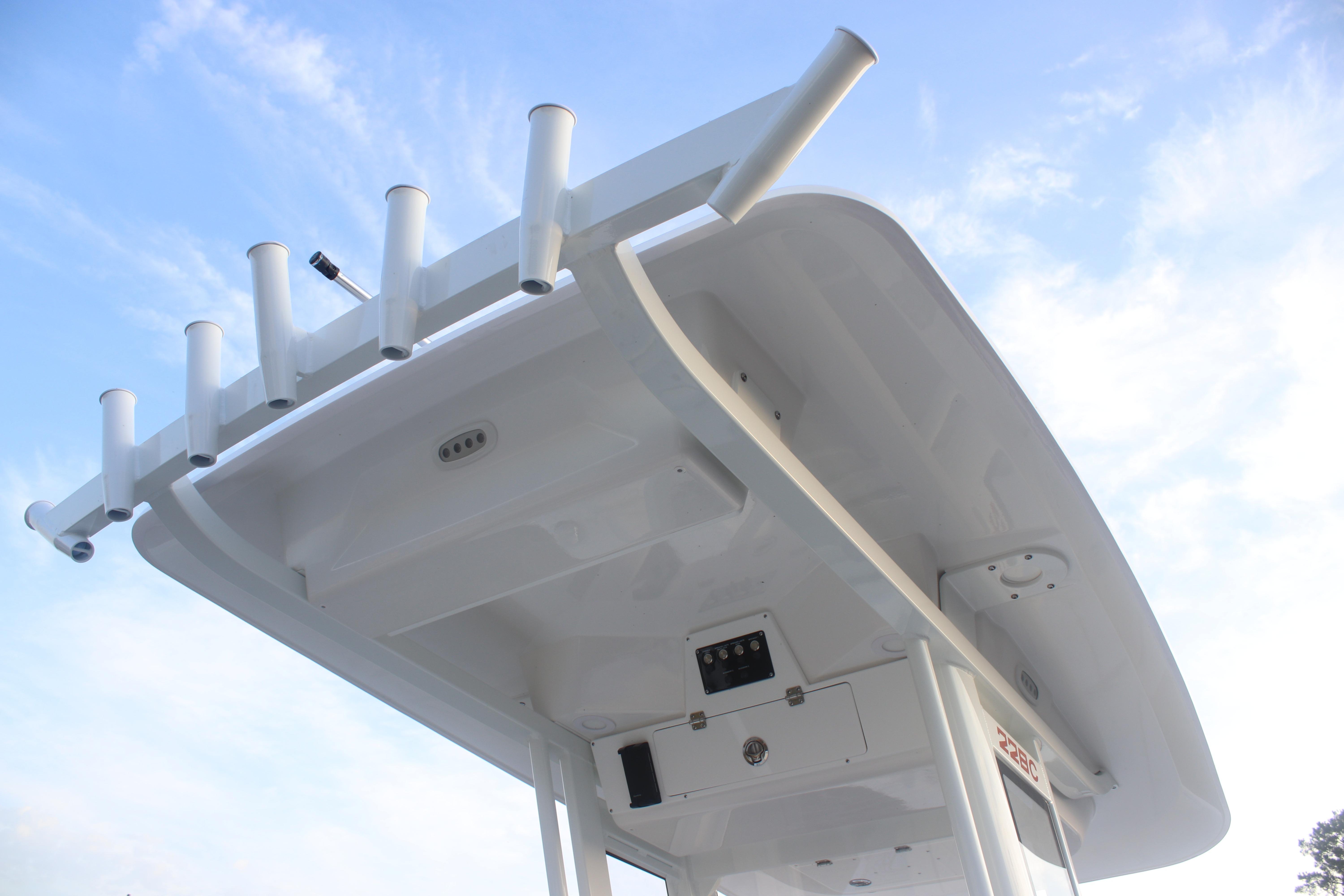 2026 Sea Fox 228 Commander boat top view with rod holders against blue sky.