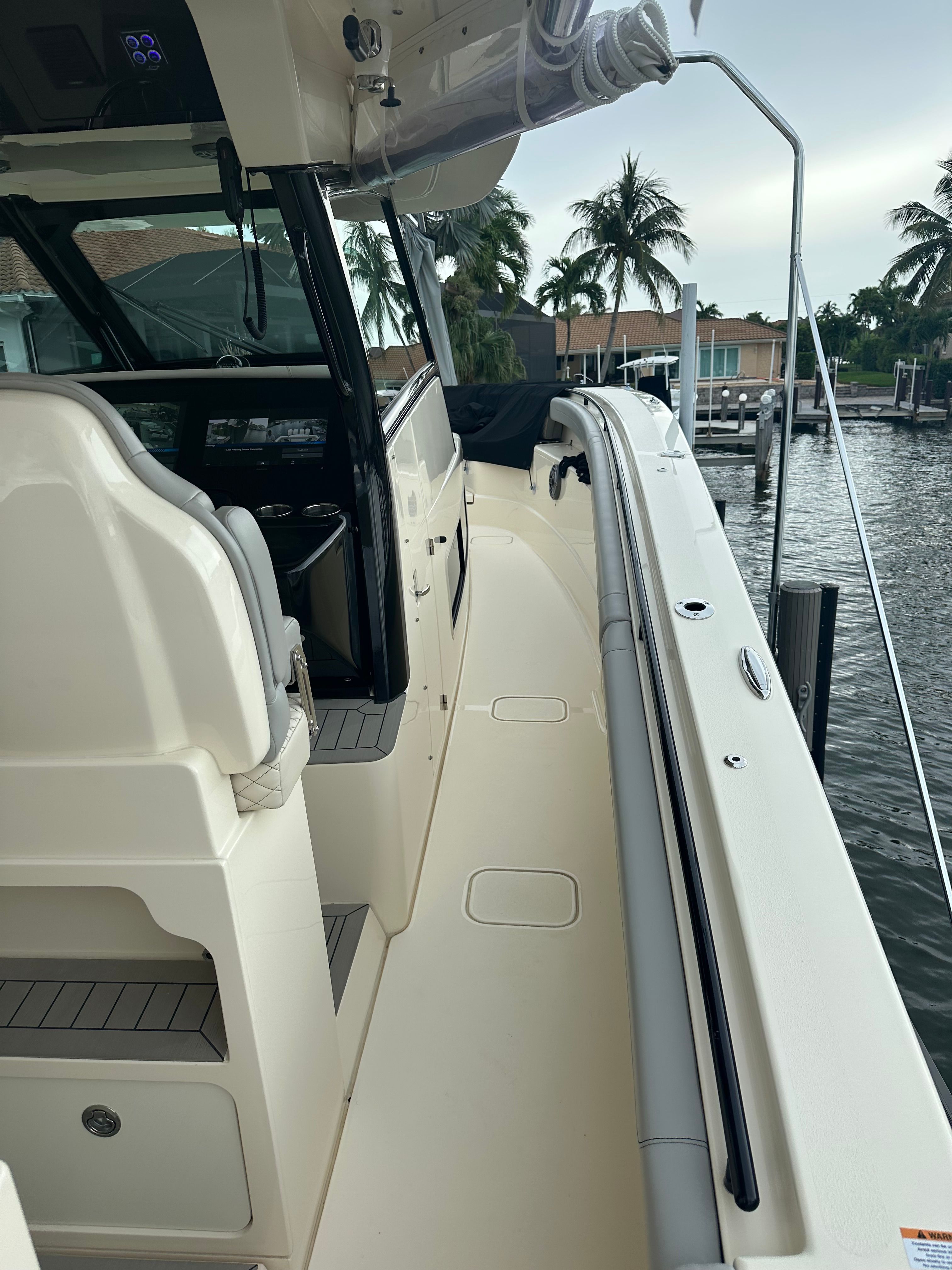 Scout 425 LXF 2022 on water with palm trees in background.