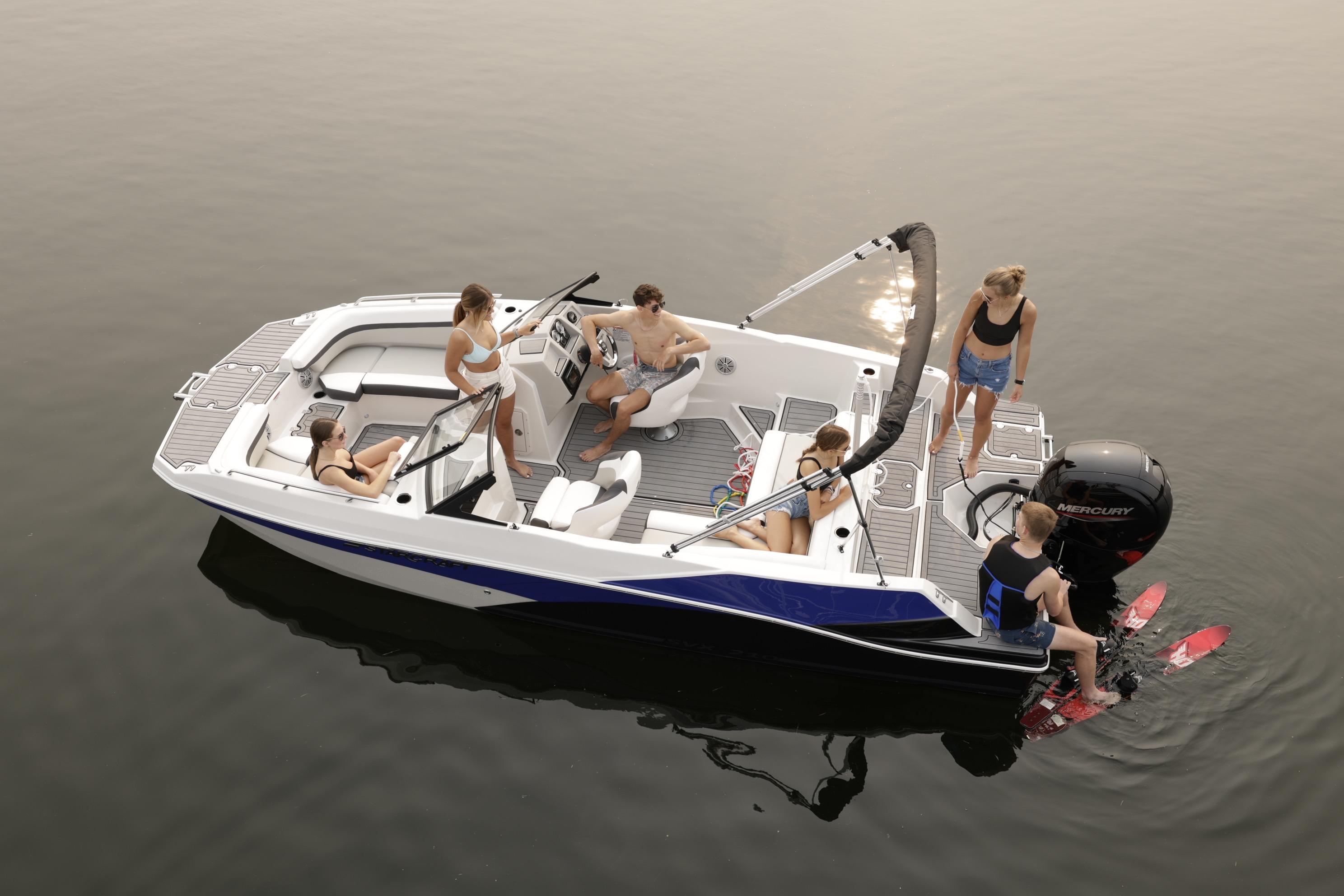 2026 Starcraft SVX 210 DC OB boat with people enjoying water activities.