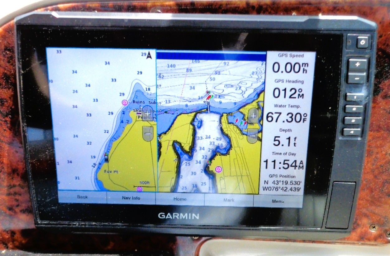 A GPS navigation system displays a map with depth readings and current data.