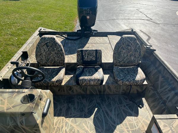 2025 Lowe Roughneck 2070 SC boat interior with camo seats and steering console.