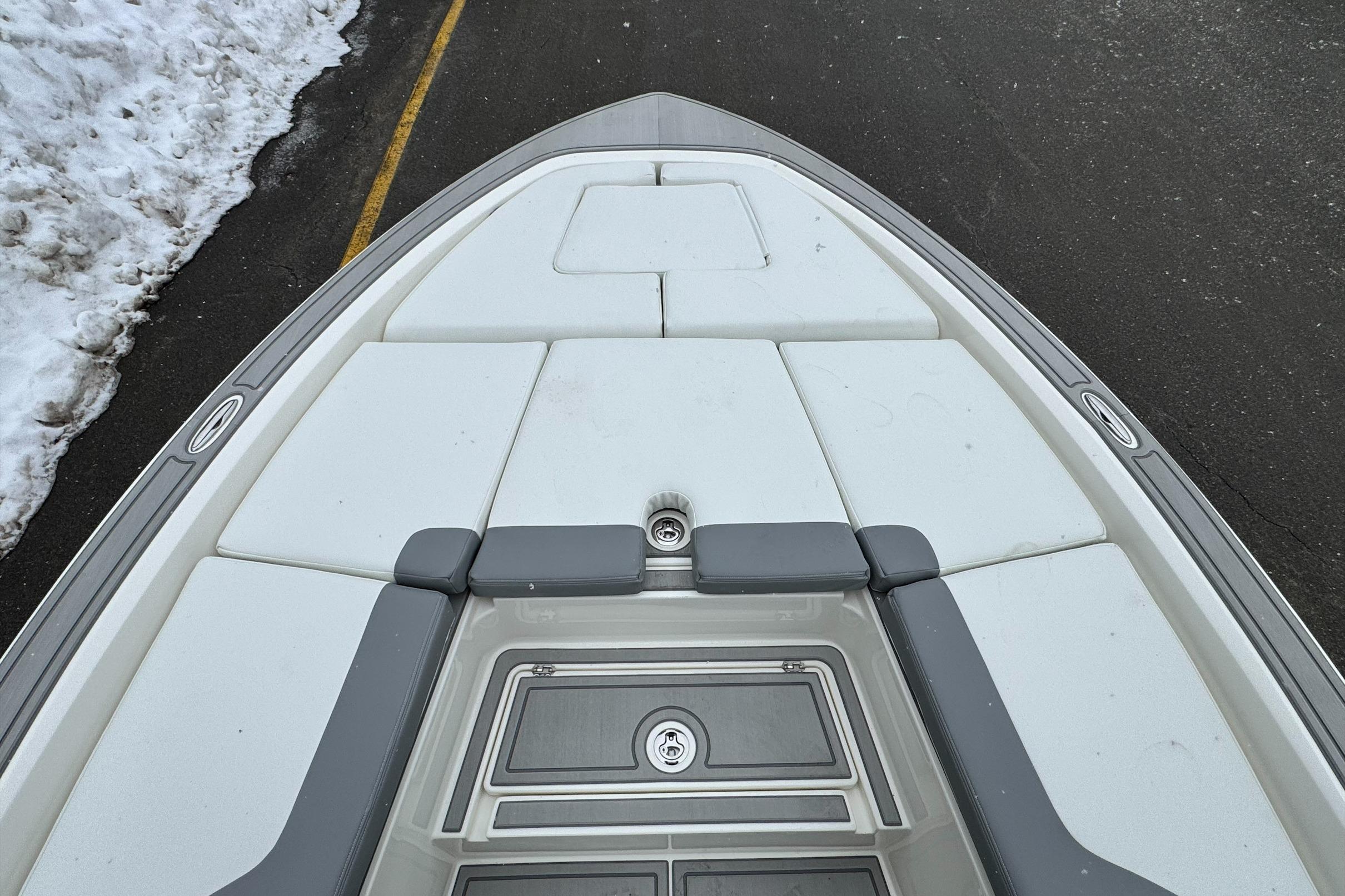 Bow view of 2026 Mako 24 APEX boat on snowy pavement.