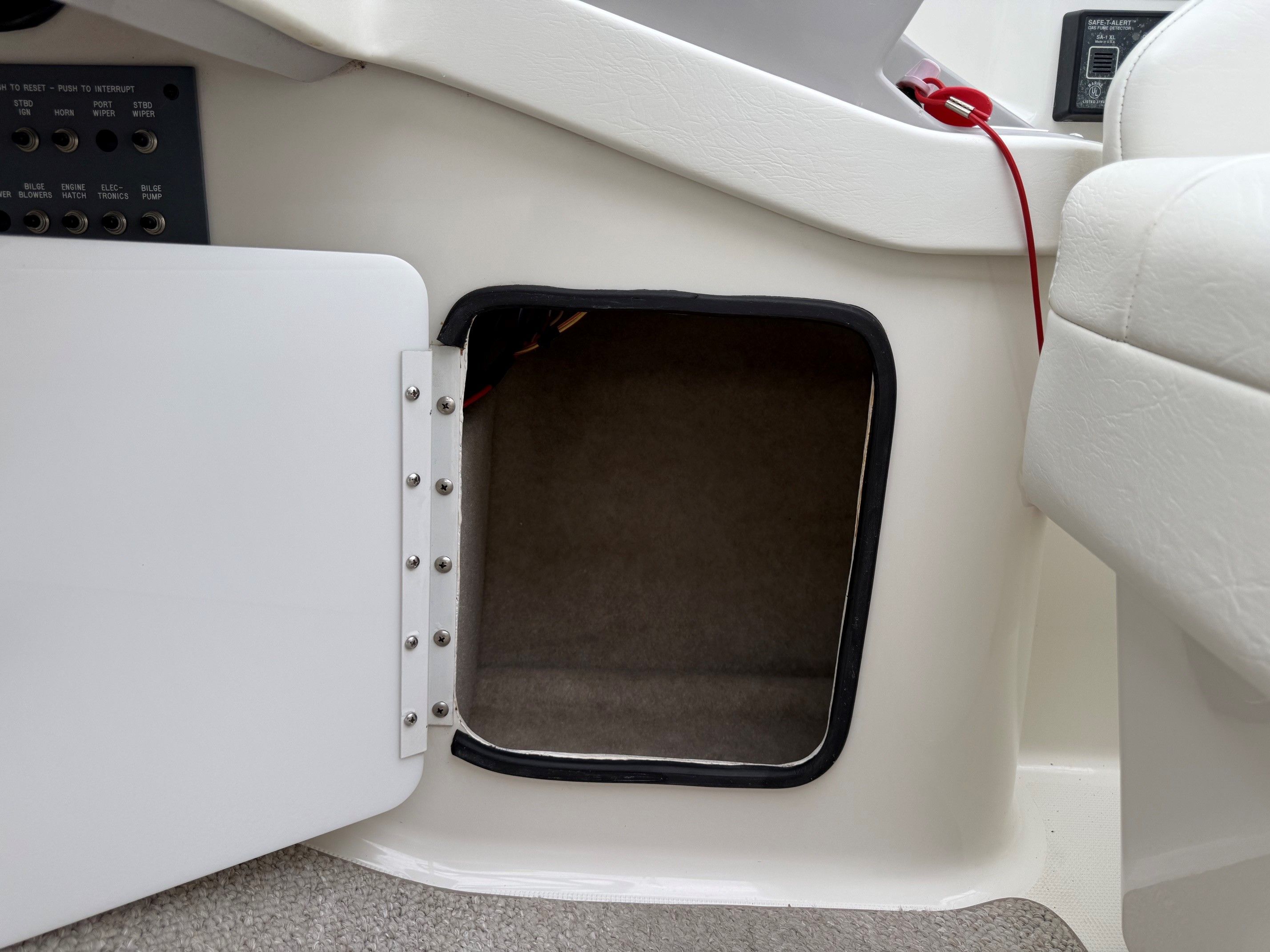 Open storage compartment in a 1998 Formula Thunderbird boat.