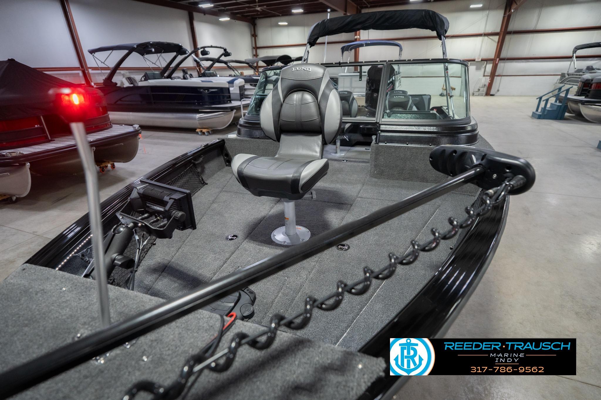 2026 Lund 2075 Impact XS boat interior in showroom with seating and equipment.